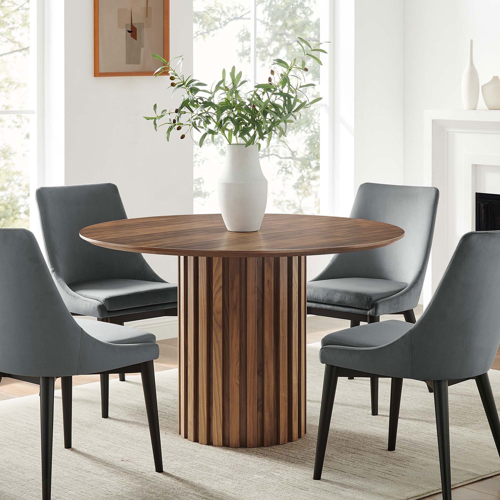 Senja round dining table centers a bright modern dining room with its fluted pedestal and warm walnut tone || EEI-6064-WAL-SET || front_room