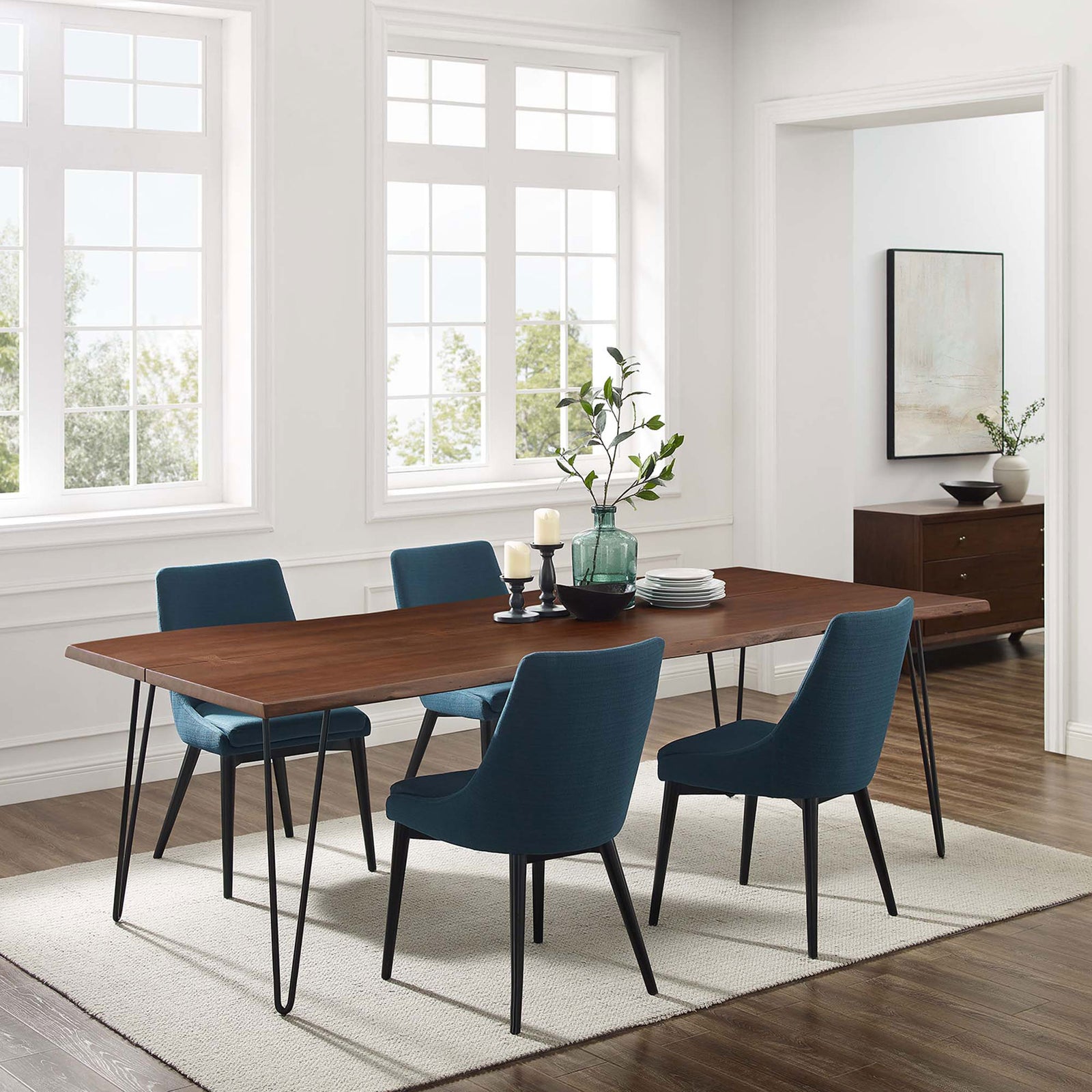 Expansive live edge acacia dining table with blue chairs anchors a bright, airy dining room setting. || EEI-6072-BLK-WAL || front_angle_room