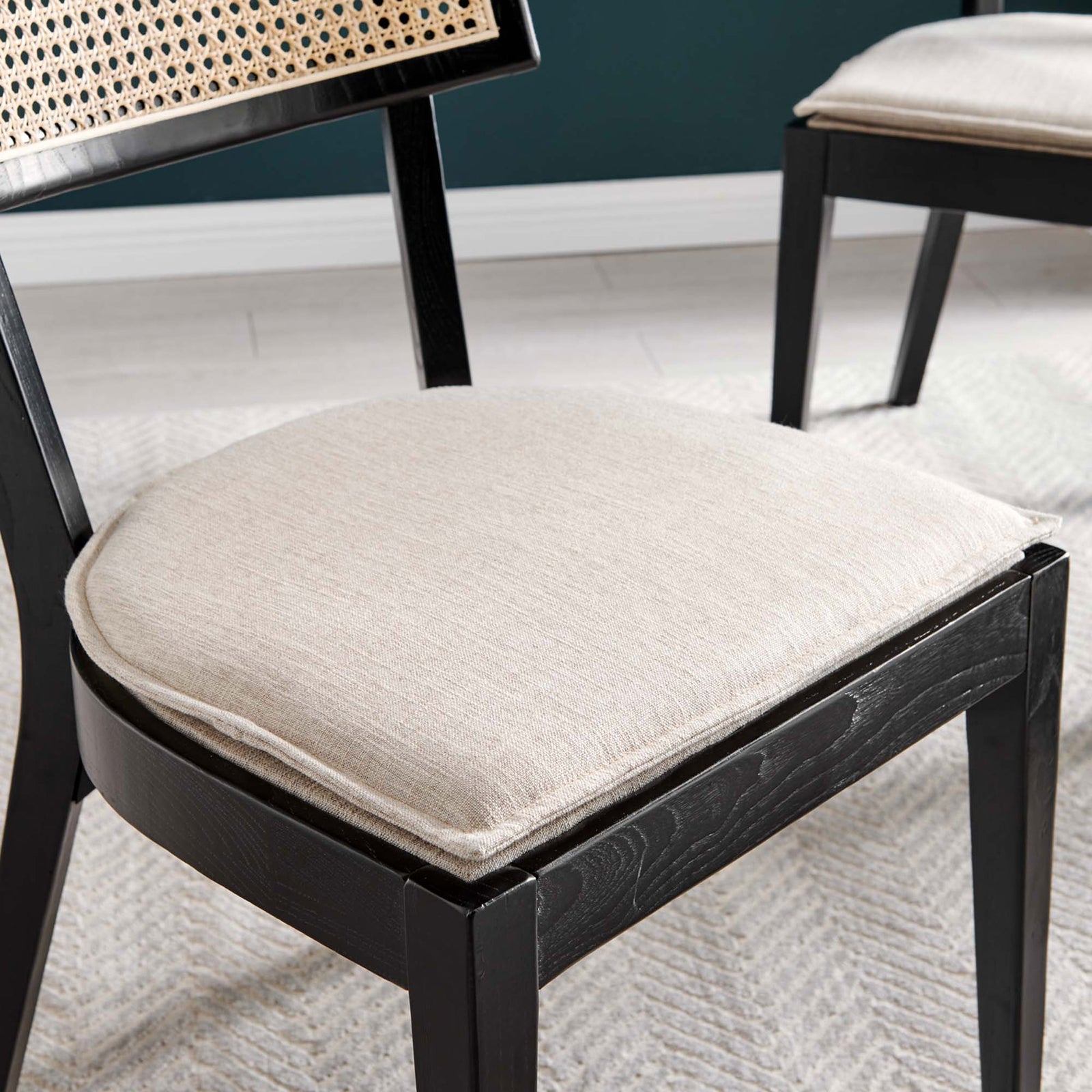 Beige fabric seat cushion on black wood dining chair bringing soft comfort to the woven rattan design || EEI-6080-BLK-BEI || detail_room