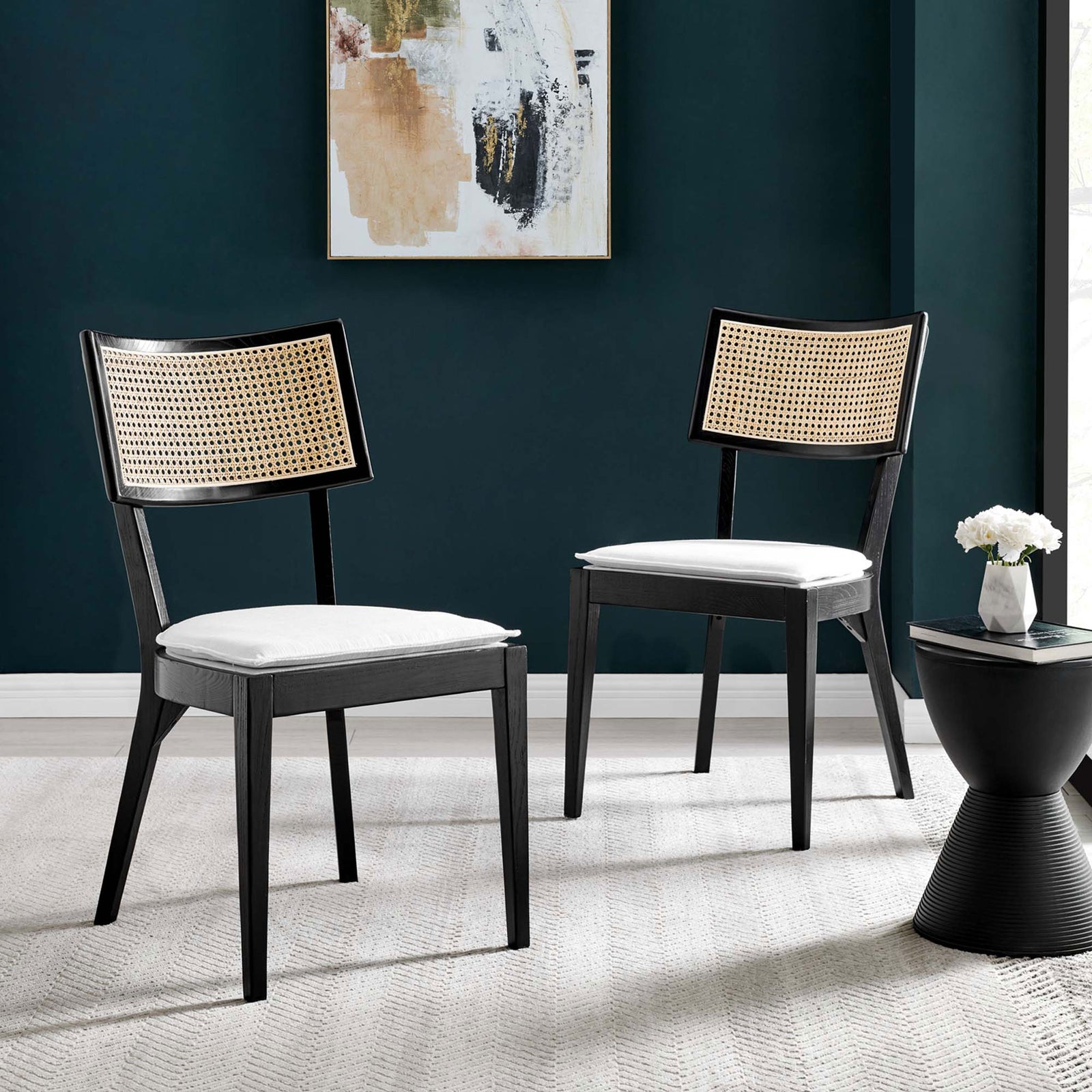 Set of two black wood dining chairs with rattan backs and white cushions in a chic room || EEI-6080-BLK-WHI || front_angle_multi_room