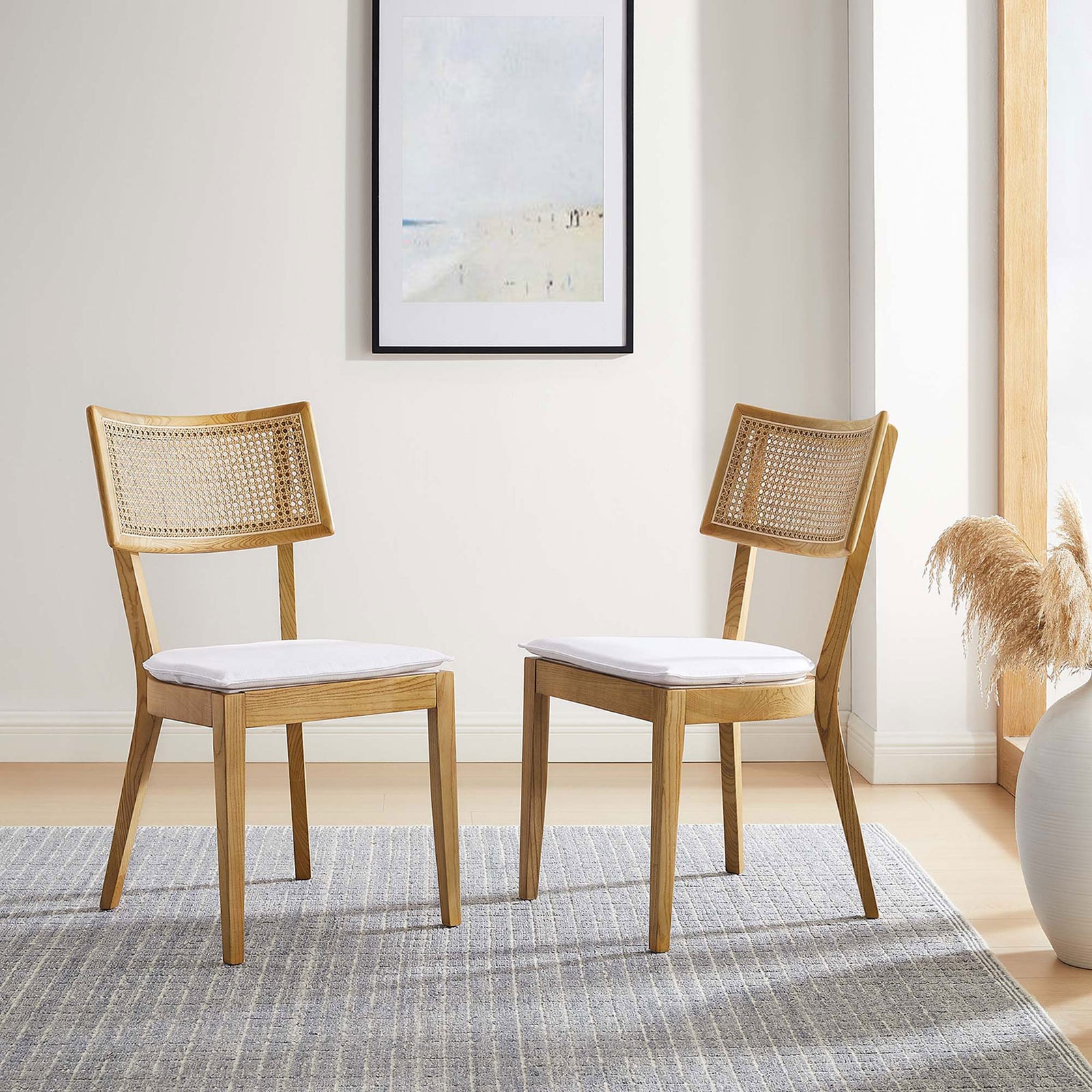 Pair of Caledonia dining chairs creates a light, relaxed look in a sunlit contemporary dining room || EEI-6080-NAT-WHI || front_angle_multi_room