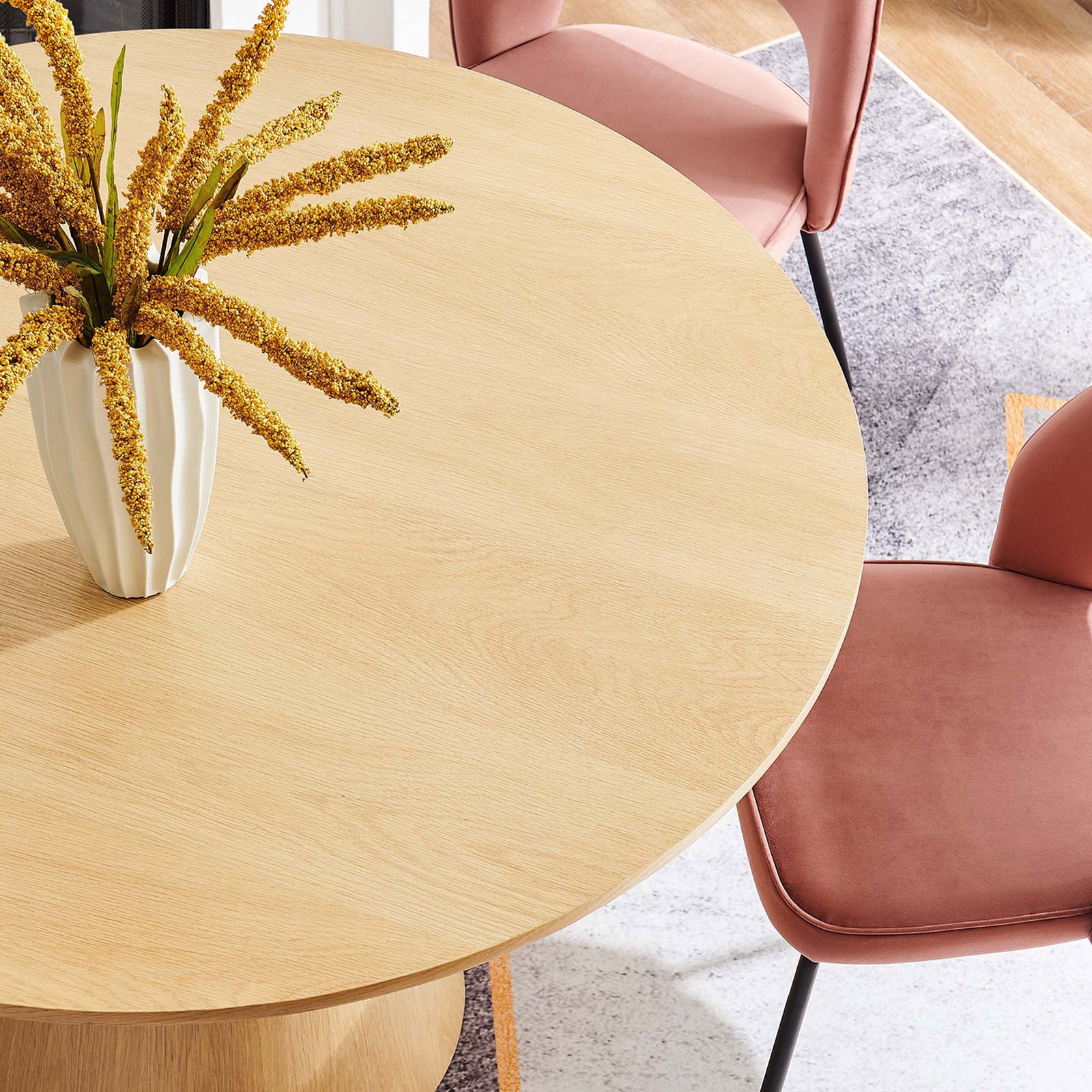 Oak round table styled with blush dining chairs and floral centerpiece for a warm inviting dining nook || EEI-6102-OAK || detail_room