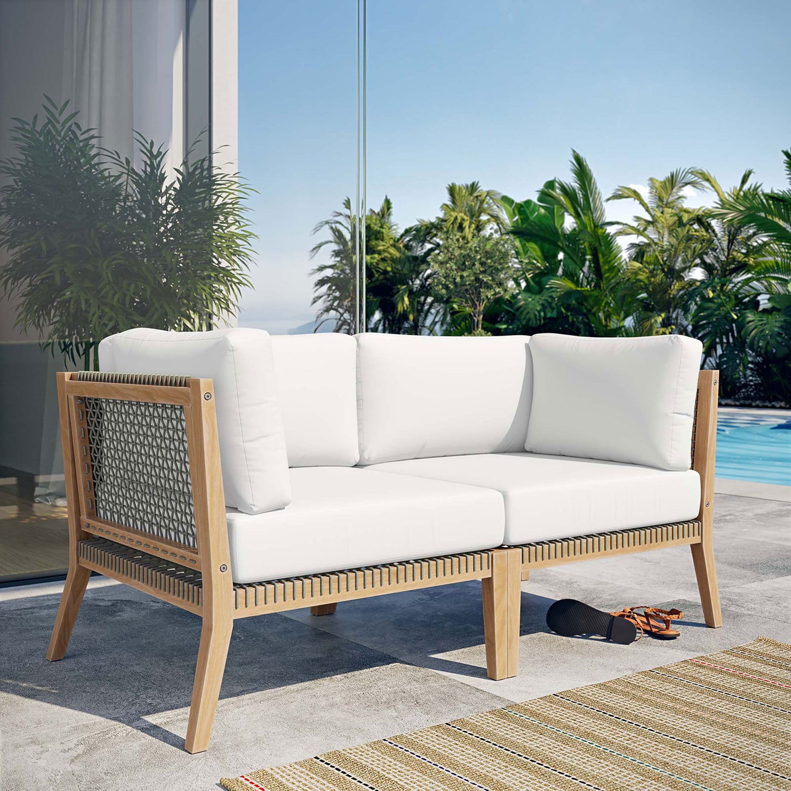Clearwater teak loveseat with white cushions styled on a sunlit poolside patio || EEI-6119-GRY-WHI || front_angle_room