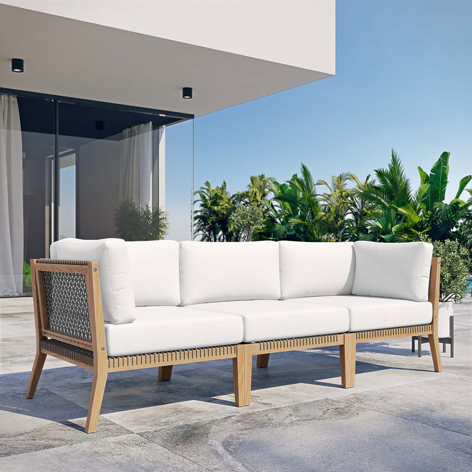 White teak outdoor sofa creating a modern lounge on a sunny patio || EEI-6120-GRY-WHI || front_angle_room