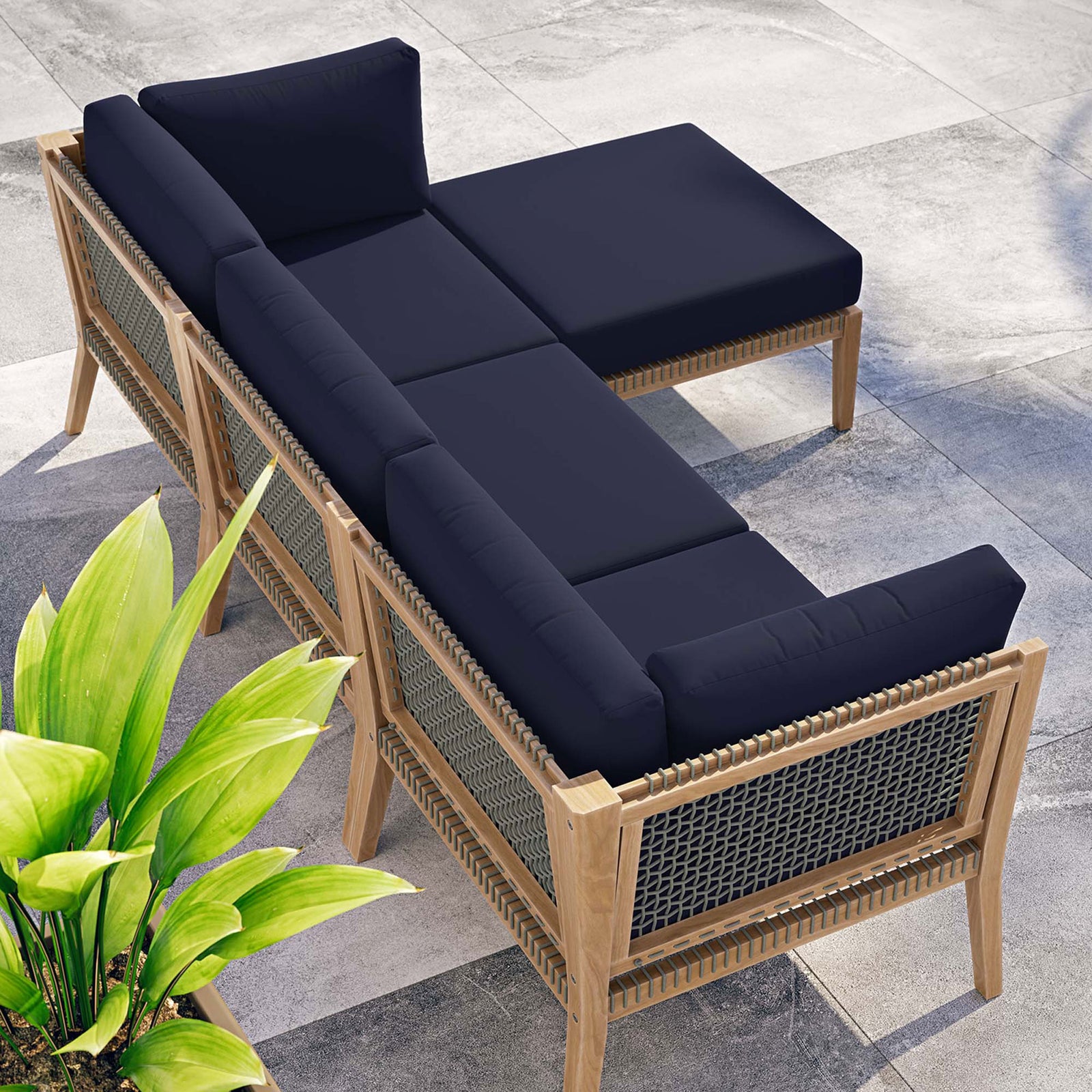 Navy blue Clearwater sectional arranged poolside to create a relaxing outdoor lounge nook || EEI-6121-GRY-NAV || top_angle_room