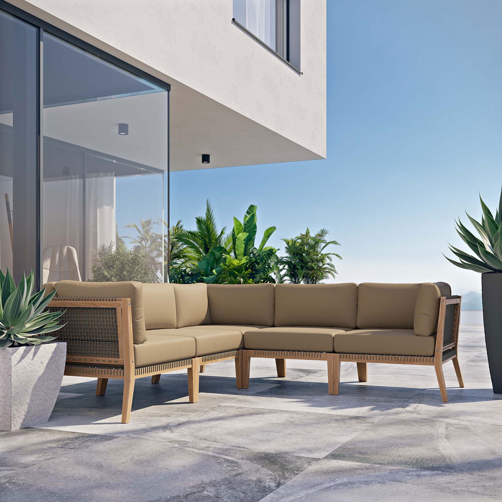 Modern outdoor terrace with light brown teak sectional styled against glass doors and tropical greenery || EEI-6123-GRY-LBR || front_angle_room