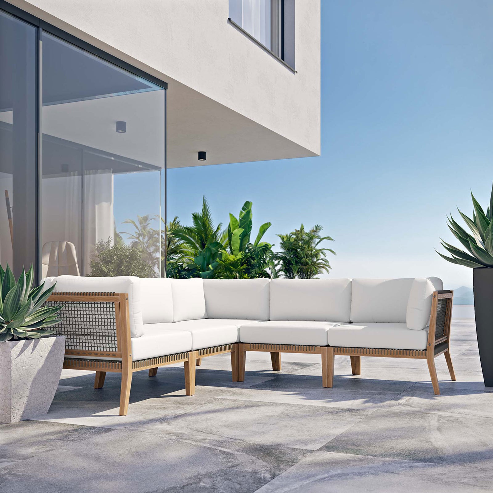 Modern outdoor terrace with white teak sectional styled against glass walls and vibrant greenery || EEI-6123-GRY-WHI || front_angle_room