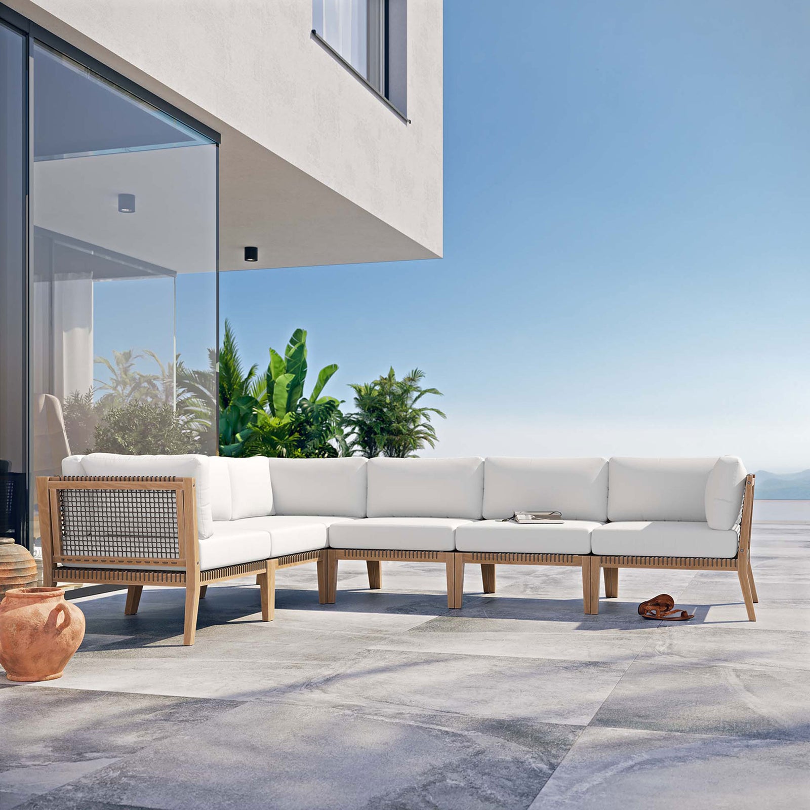 White sectional styled on a sunny terrace with ocean and greenery backdrop || EEI-6125-GRY-WHI || front_angle_room