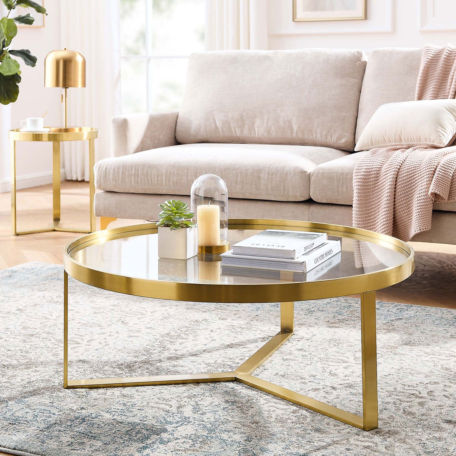 Brushed gold coffee table anchors the seating area with a luminous glass top || EEI-6153-GLD || front_angle_room
