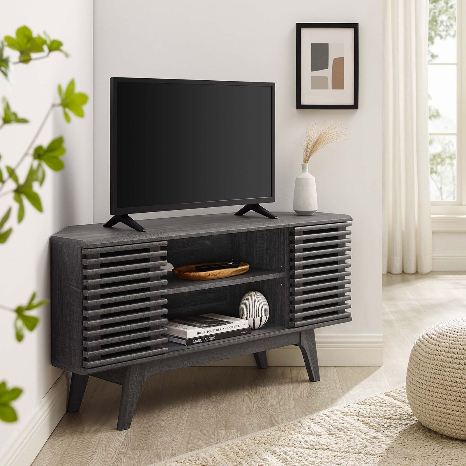 Charcoal corner TV stand with TV and decor creates a cozy modern media hub in a bright living room || EEI-6157-CHA || front_angle_room
