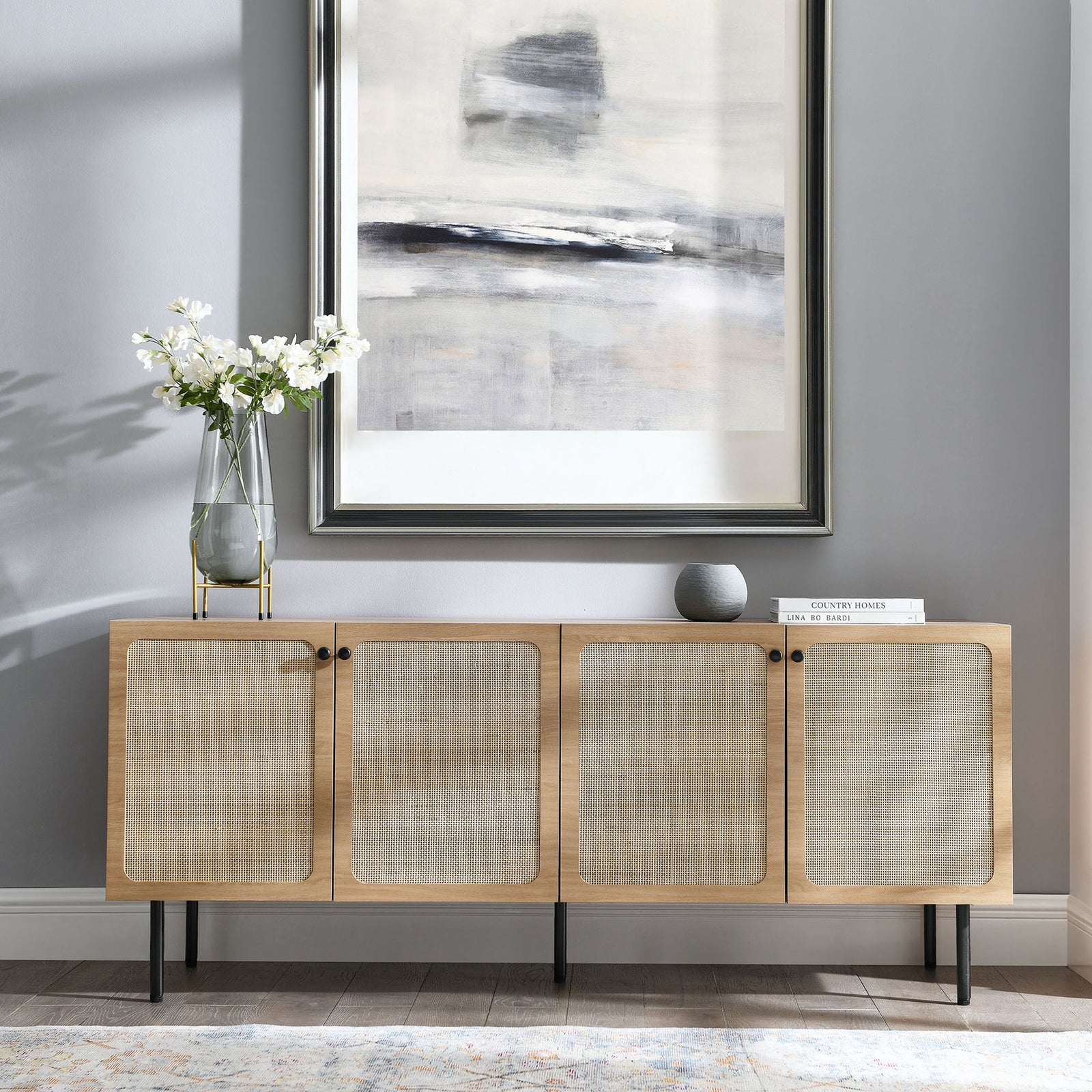 Oak sideboard styled in a modern living space with framed art, decor accents, and area rug || EEI-6201-OAK || front_angle_room