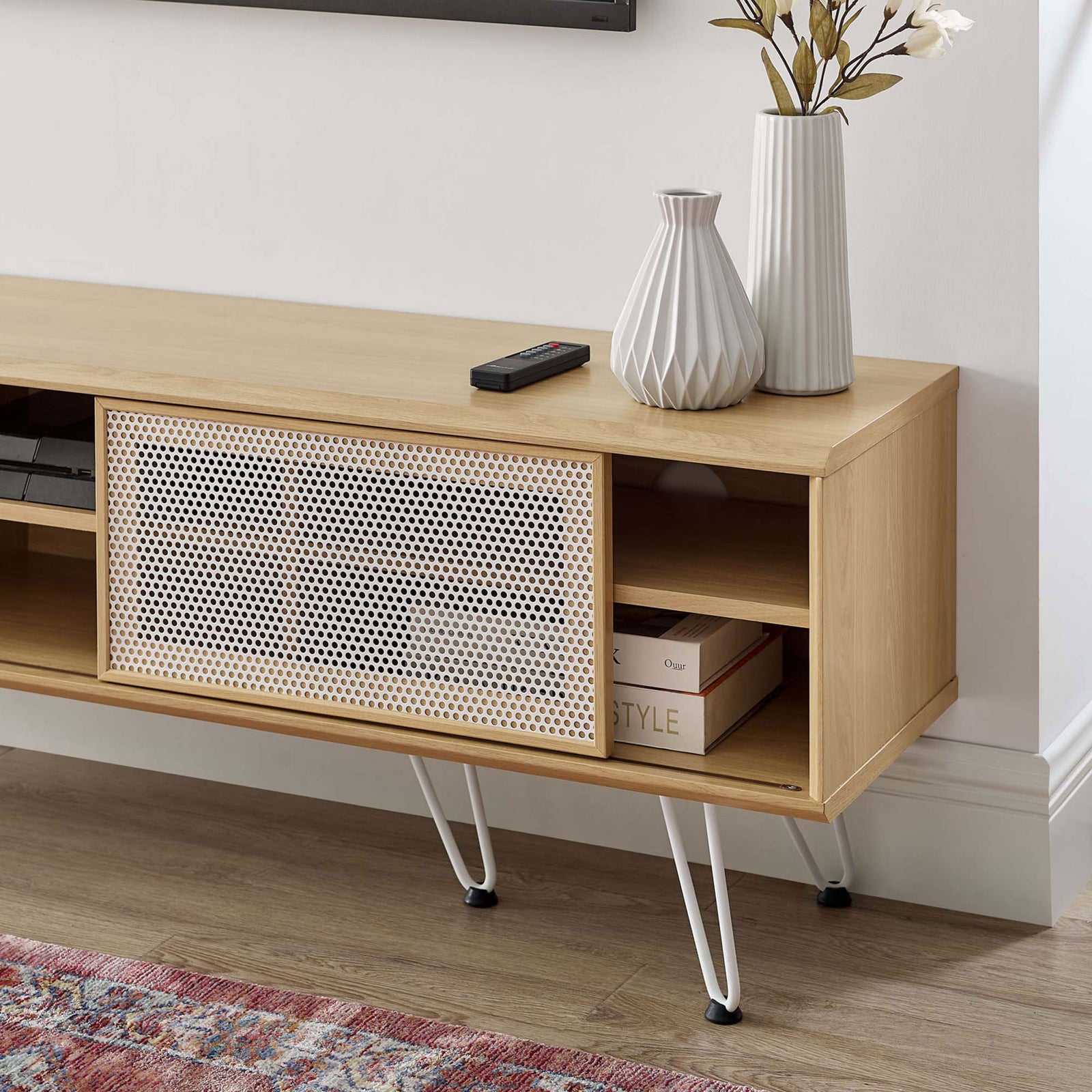 Oak TV stand styled with decor, showing open shelves for consoles and books beside the sliding white mesh door || EEI-6203-OAK || storage_room