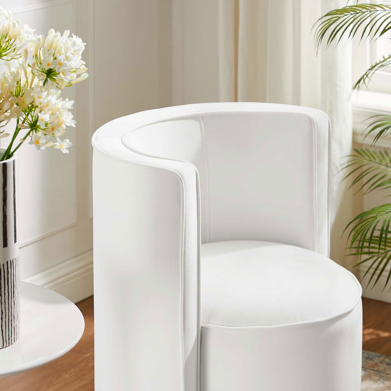 Soft white velvet upholstery and a sculpted backrest add refined texture to this room-ready swivel chair || EEI-6222-WHI || detail_room