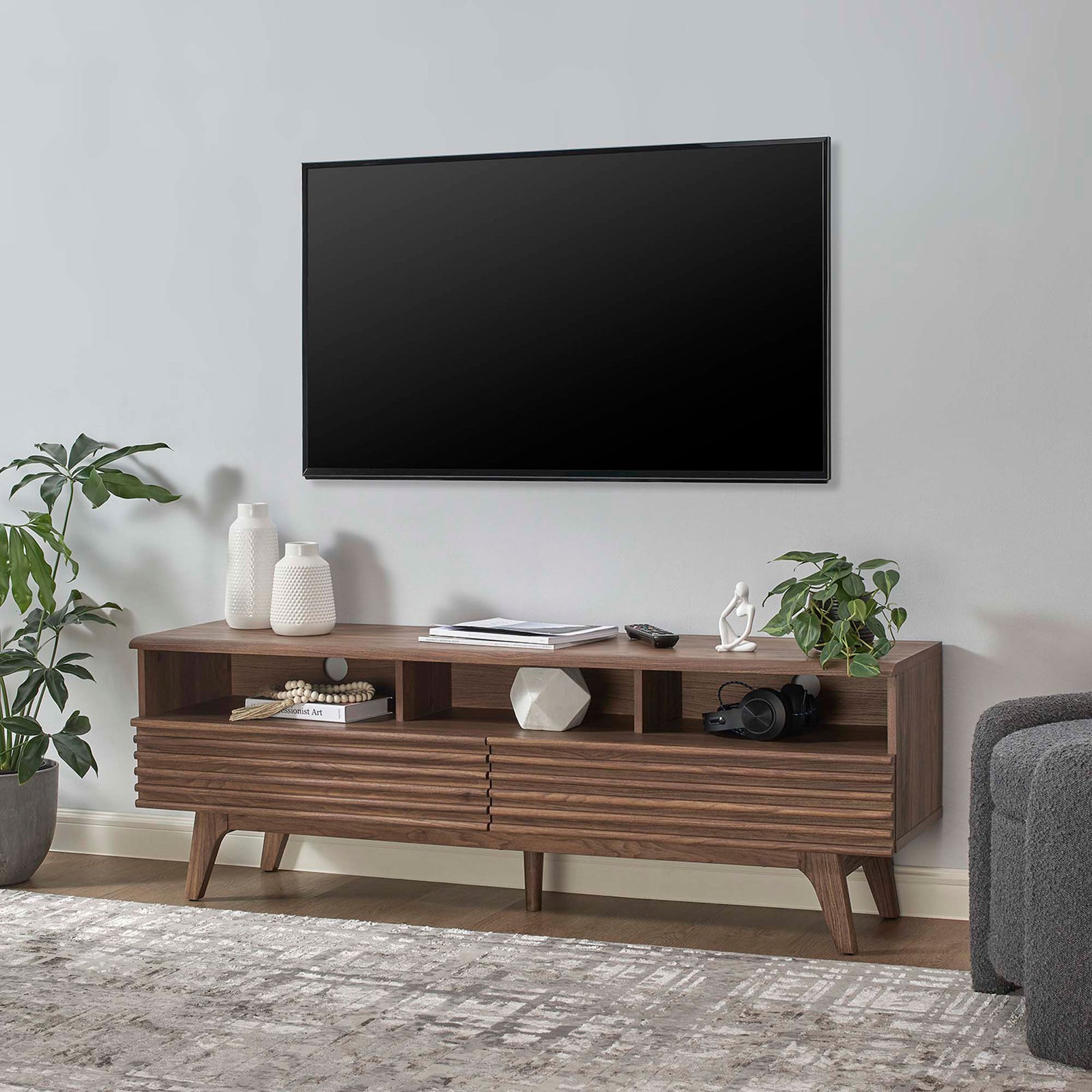 Walnut TV stand in modern living room holding decor with one drawer open for convenient storage || EEI-6228-WAL || front_angle_open_room