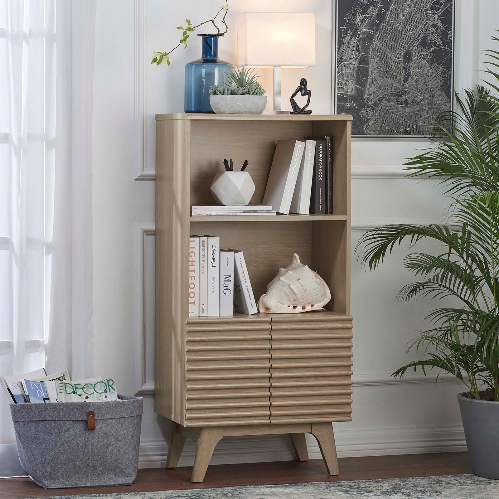 Styled as a living room bookcase with warm oak texture and slatted cabinet doors || EEI-6229-OAK || front_angle_room