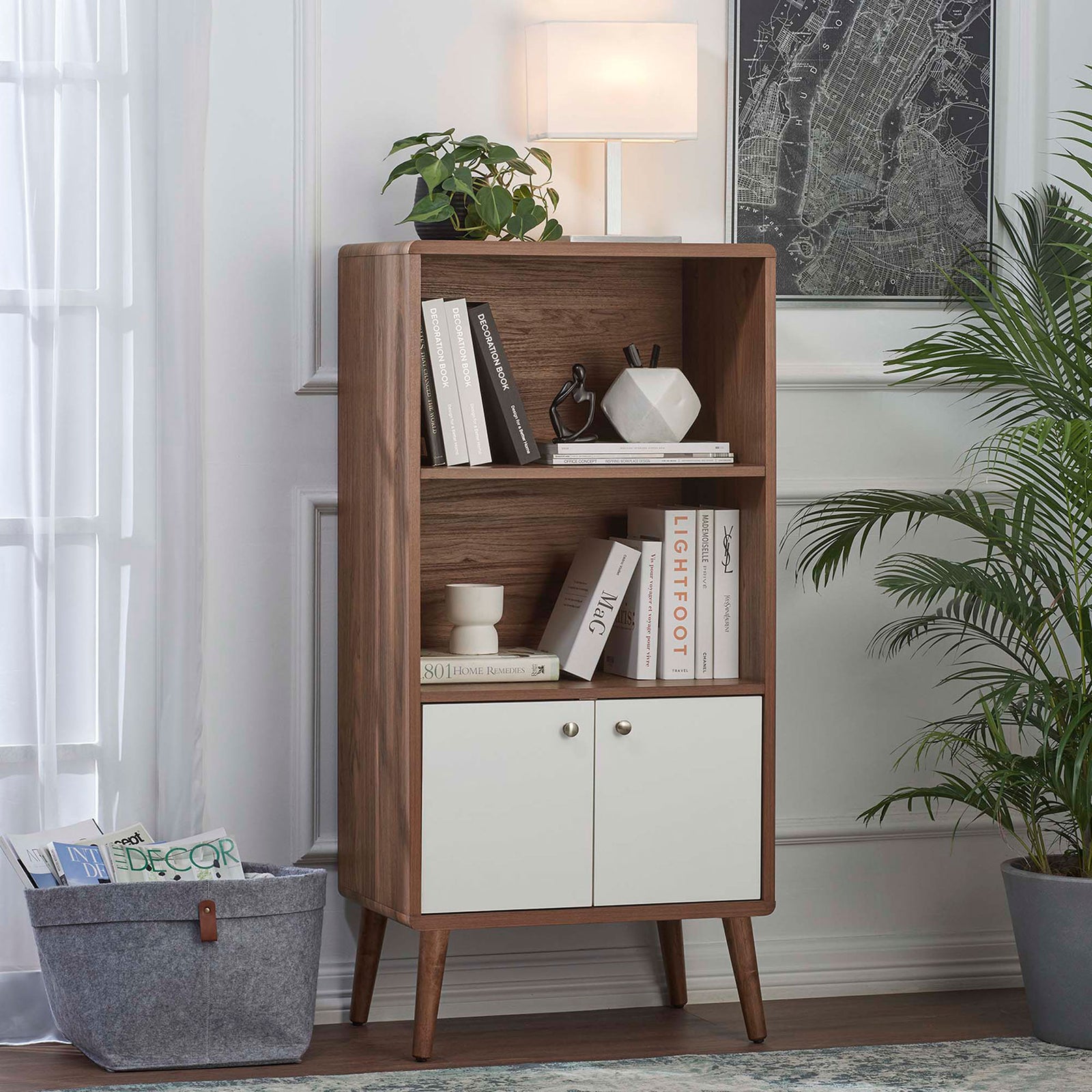 Mid-century bookcase cabinet offers open display space with hidden storage behind white doors. || EEI-6230-WAL-WHI || front_angle_room