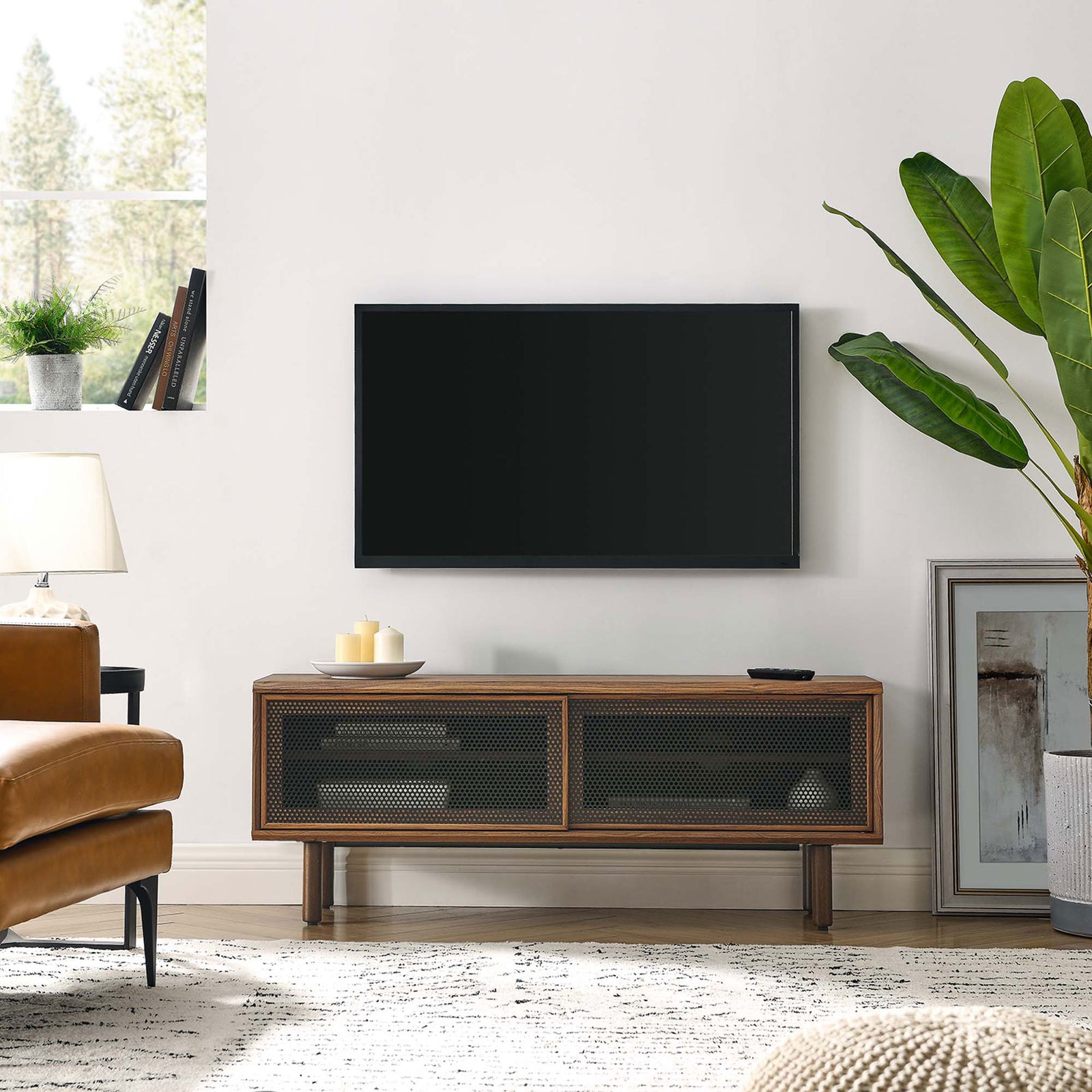 Kurtis 47 in walnut TV stand in a cozy living room beneath a wall-mounted television || EEI-6233-WAL || front_angle_room