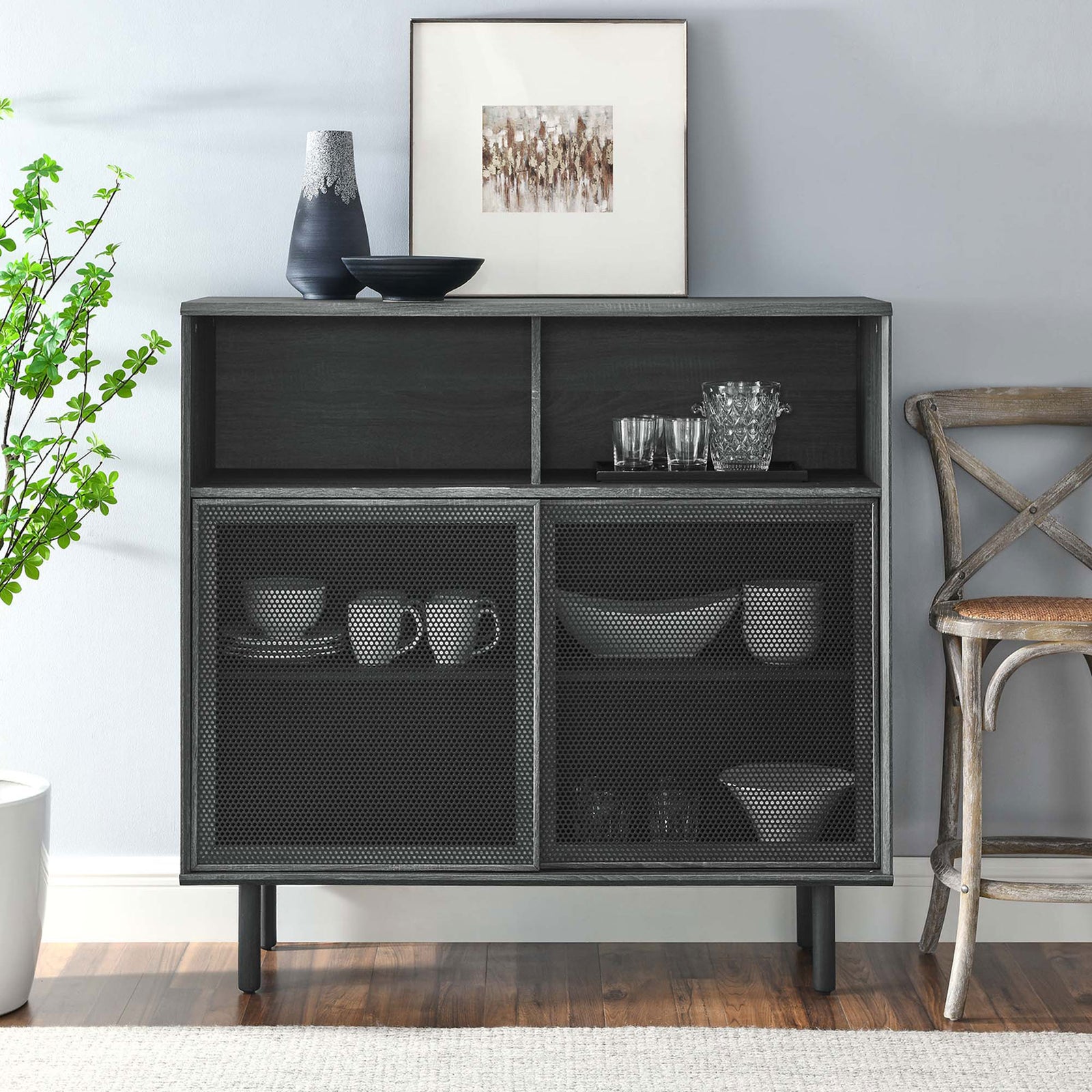 Charcoal display cabinet styled with art and serveware, adding moody industrial character to a modern dining nook. || EEI-6237-CHA || front_room