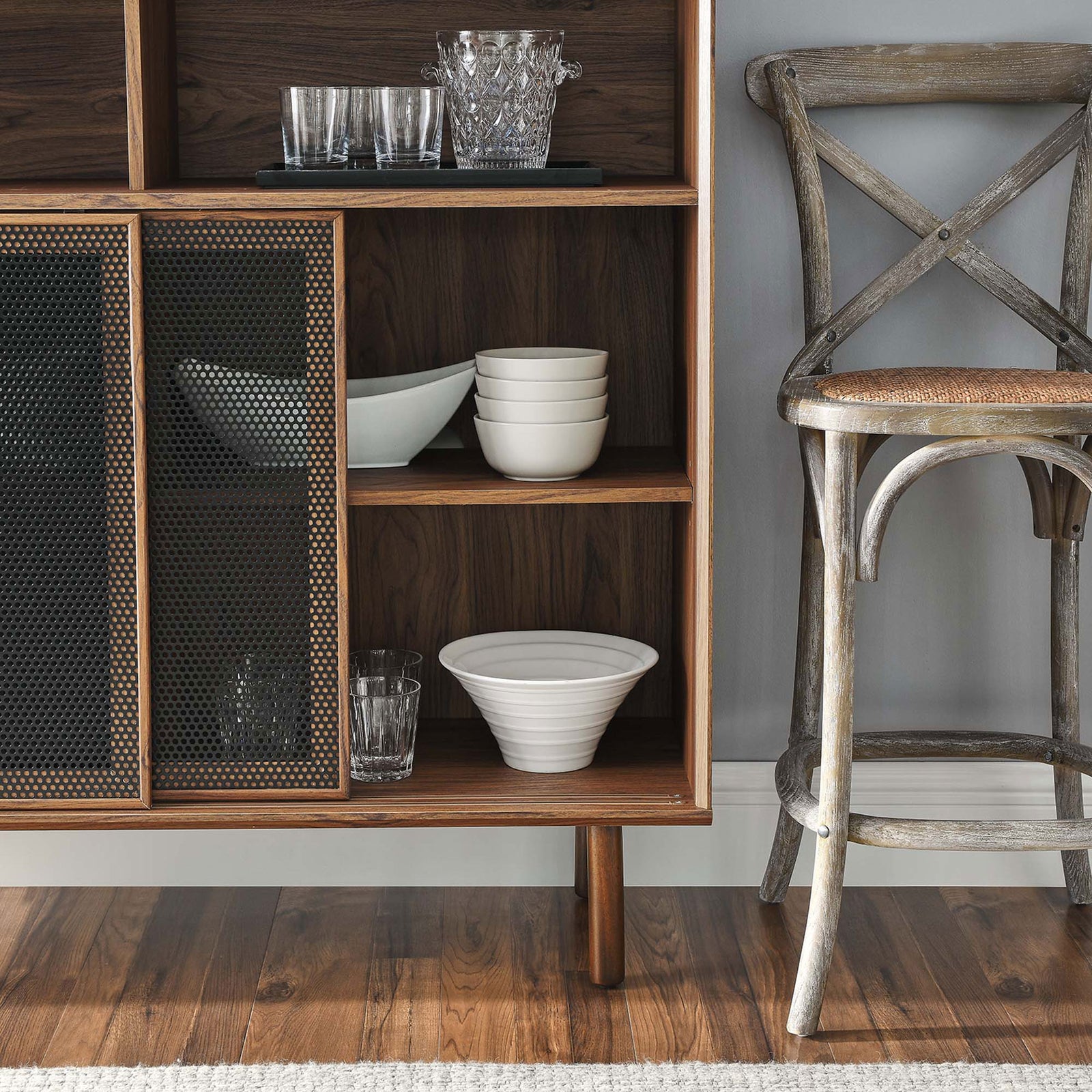 Walnut shelves organize everyday dishes while dark mesh doors lend depth and pattern to the storage area. || EEI-6237-WAL || detail_room