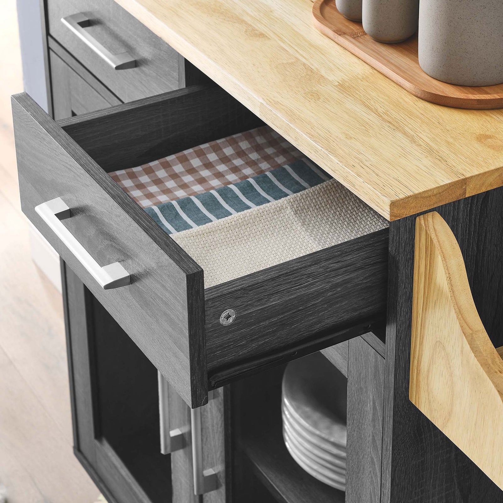 Open top drawer of kitchen cart styled with linens, showcasing smooth glide function in a modern kitchen || EEI-6276-CHA-NAT || storage_open_room