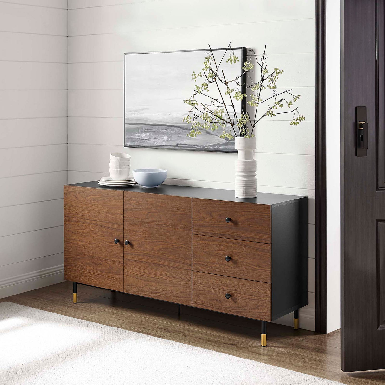 Nexus black walnut sideboard styled as a sleek living room console with decor, artwork, and modern gold accents || EEI-6283-BLK-WAL || front_angle_room