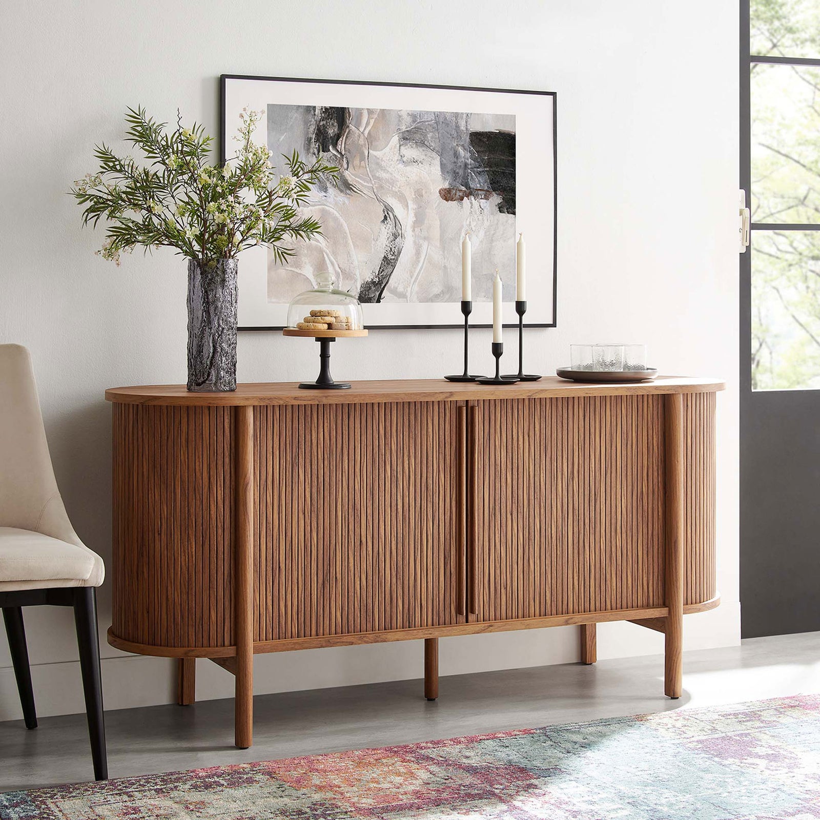 Walnut fluted sideboard styled with artwork, greenery, and desserts for an inviting entryway look || EEI-6309-WAL || front_angle_room