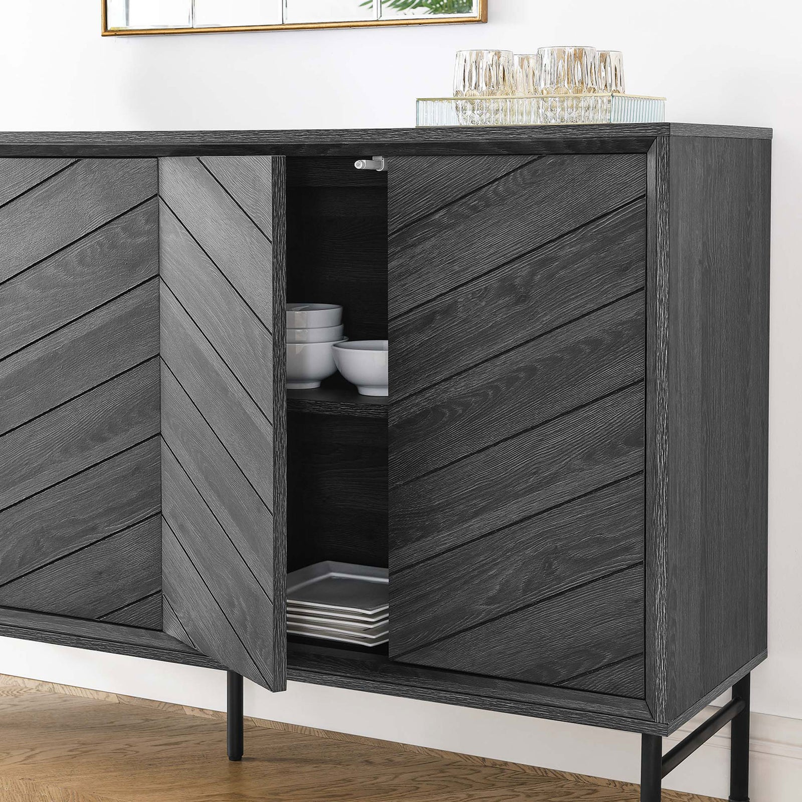 Chevron sideboard styled in a dining room with cabinet open to reveal stacked dishes and serveware || EEI-6336-BLK || storage_open_room