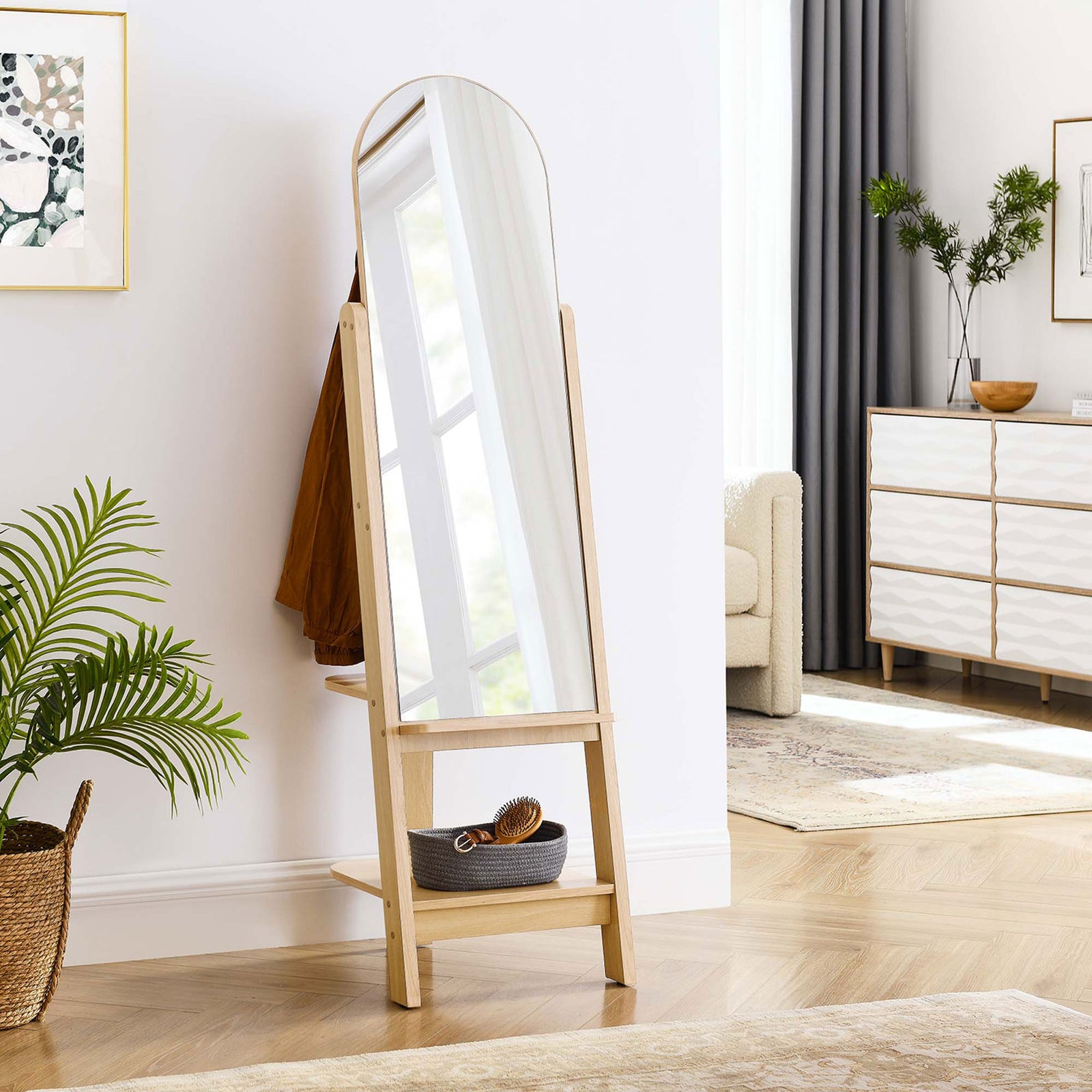 Ascend oak standing mirror styled in an entryway with coat, woven basket, and potted plant || EEI-6346-OAK || front_angle_room