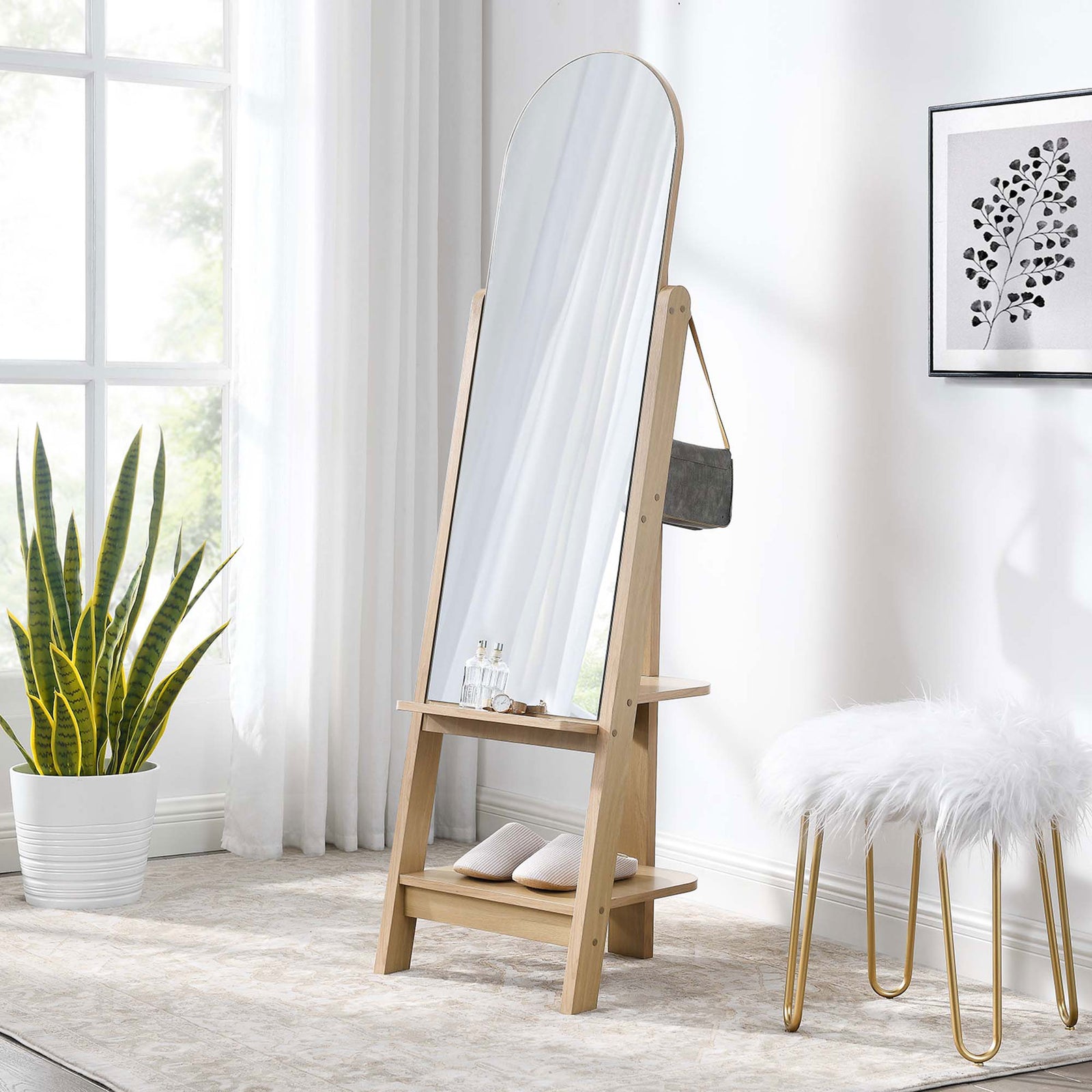 Ascend oak standing mirror in a cozy bedroom with layered rug, stool, and greenery || EEI-6346-OAK || front_angle_room