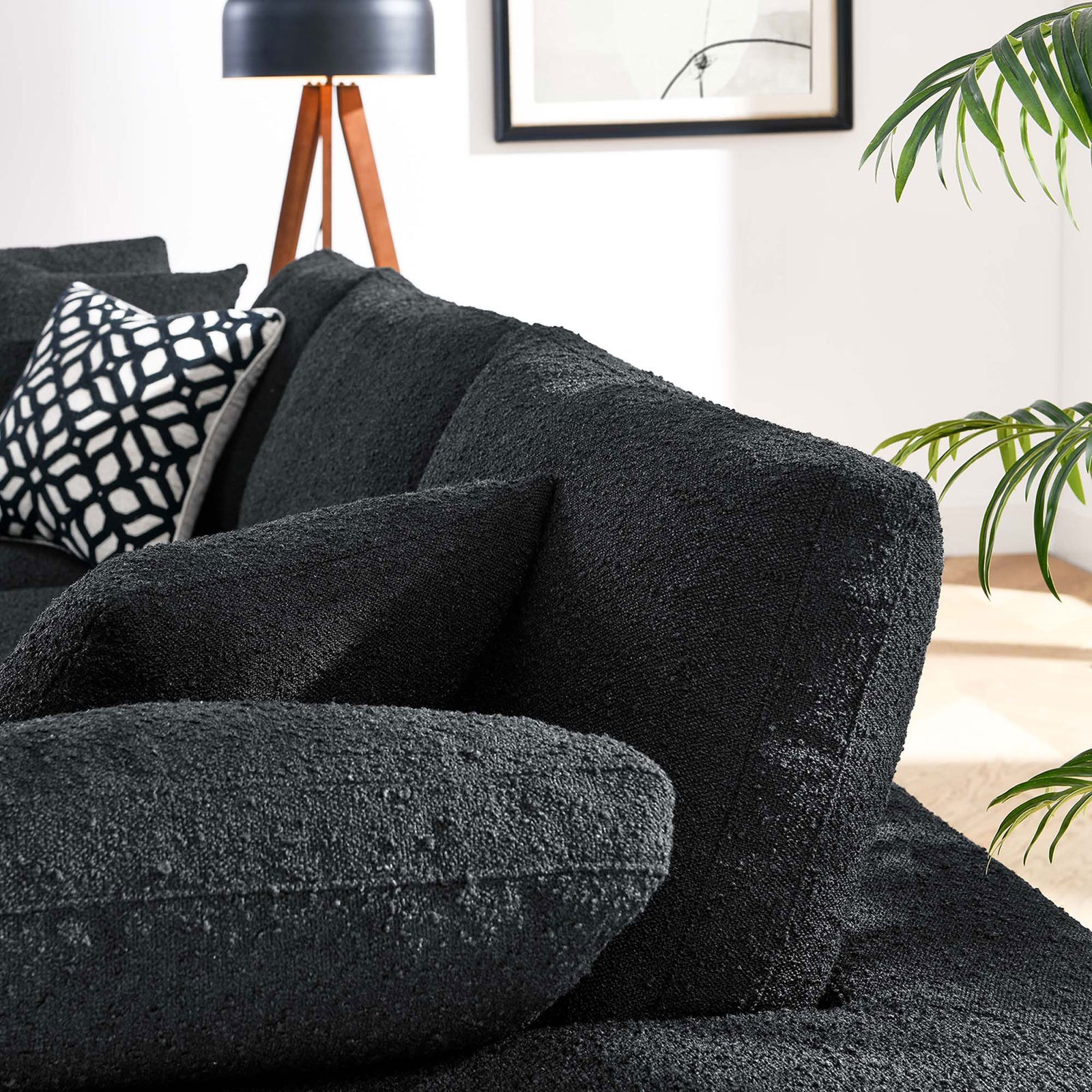 Plush black boucle sofa cushions and arm showcasing the cozy textured upholstery in a modern room || EEI-6362-BLK || detail_room