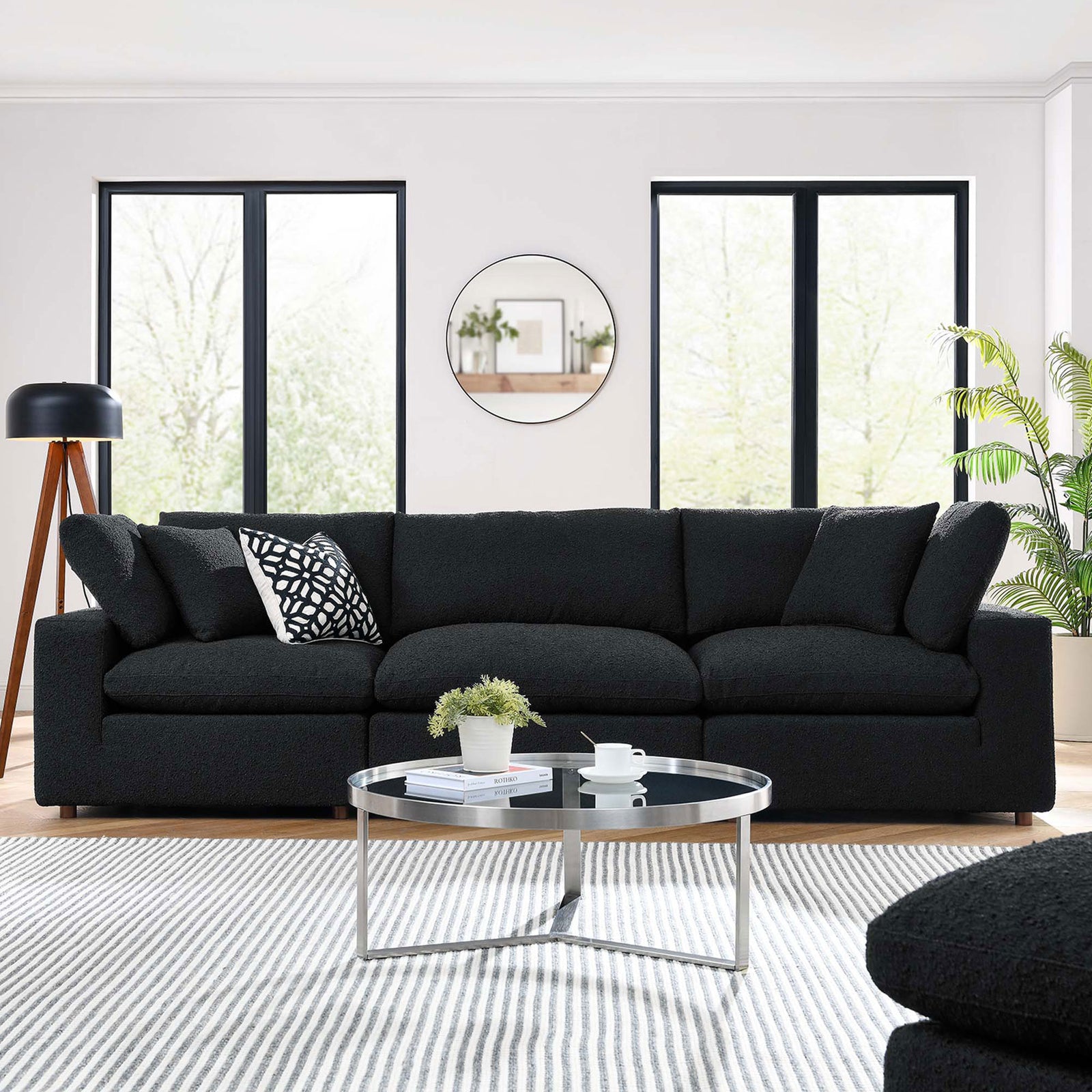 Black boucle three seat sofa styled in a bright modern living room with patterned pillow and round glass table || EEI-6362-BLK || front_room