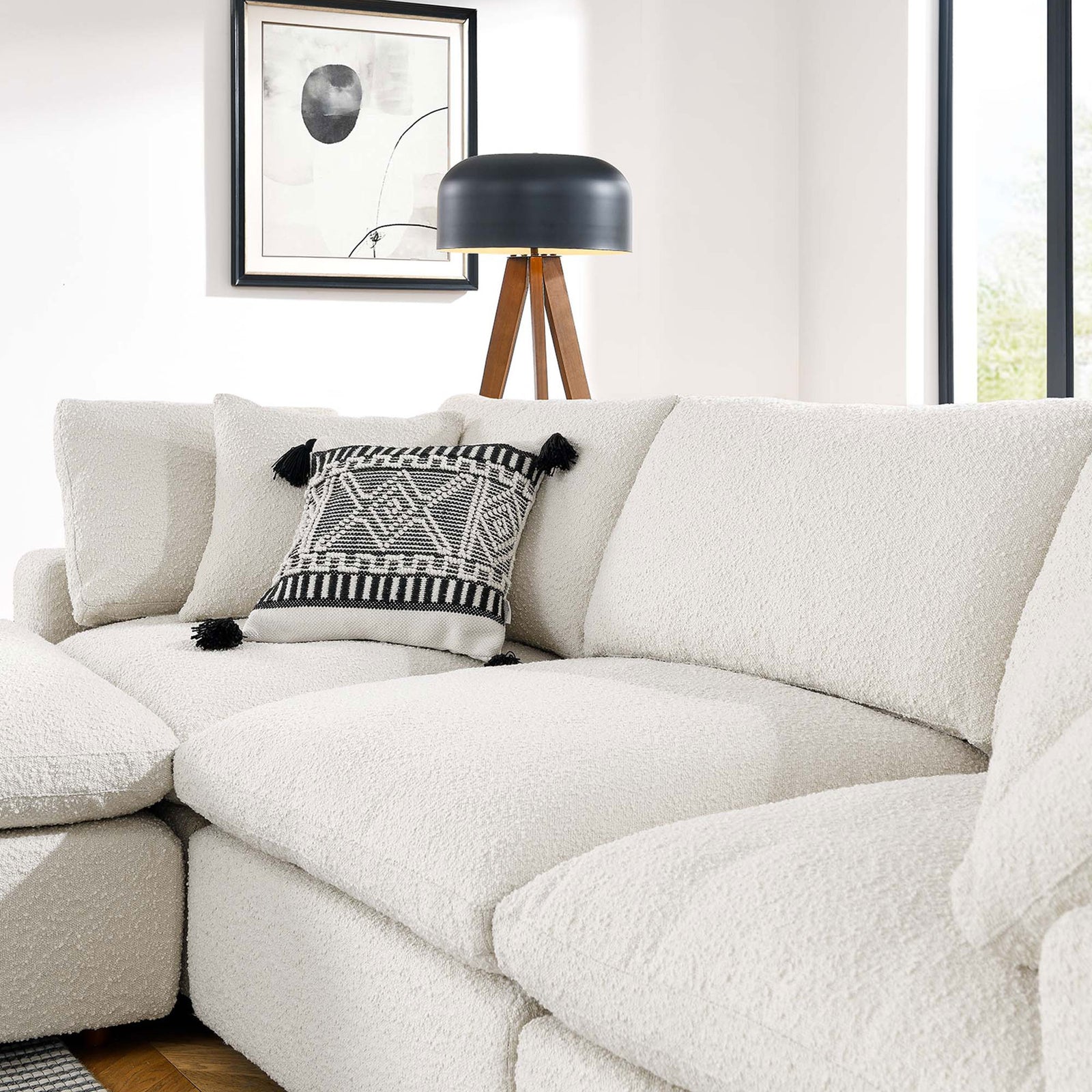 Soft ivory boucle cushions showcasing the nubby texture and layered pillows in a contemporary living room || EEI-6363-IVO || detail_room