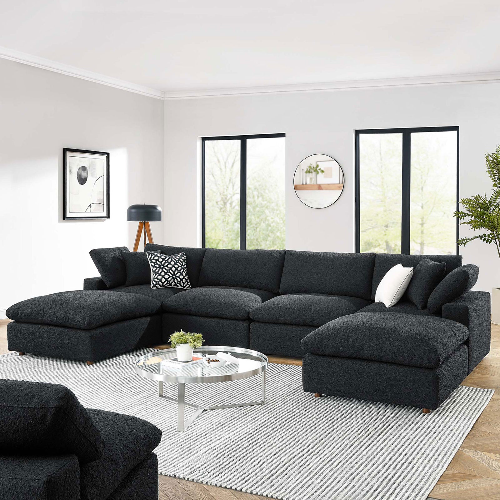 Black boucle Commix sectional styled in a bright living room with layered pillows and a modern round coffee table || EEI-6366-BLK || front_angle_room