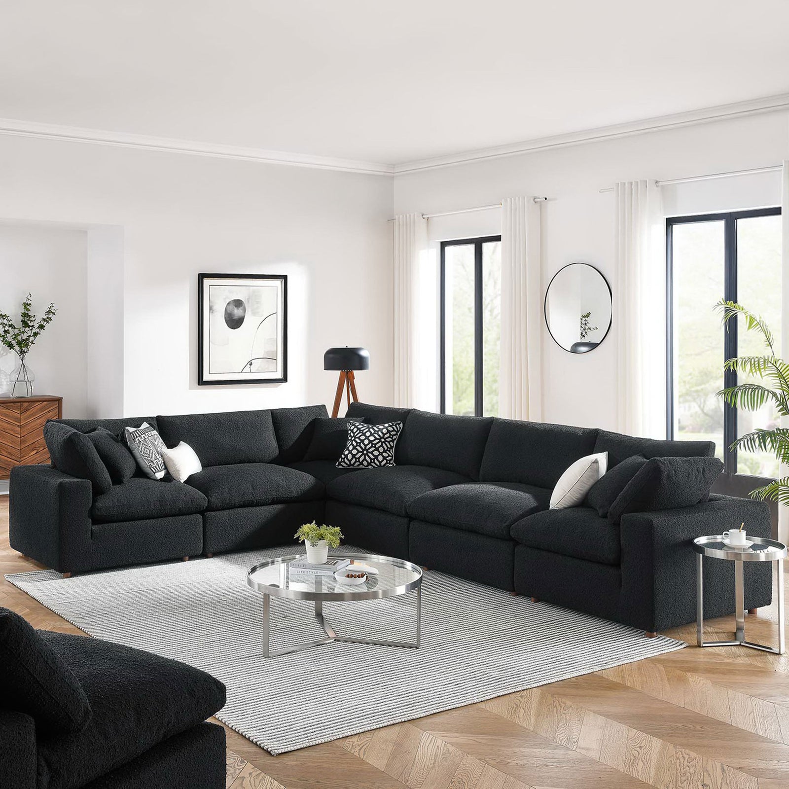 Black boucle modular sectional sofa anchoring a bright living room with modern decor and layered neutrals || EEI-6369-BLK || front_angle_room