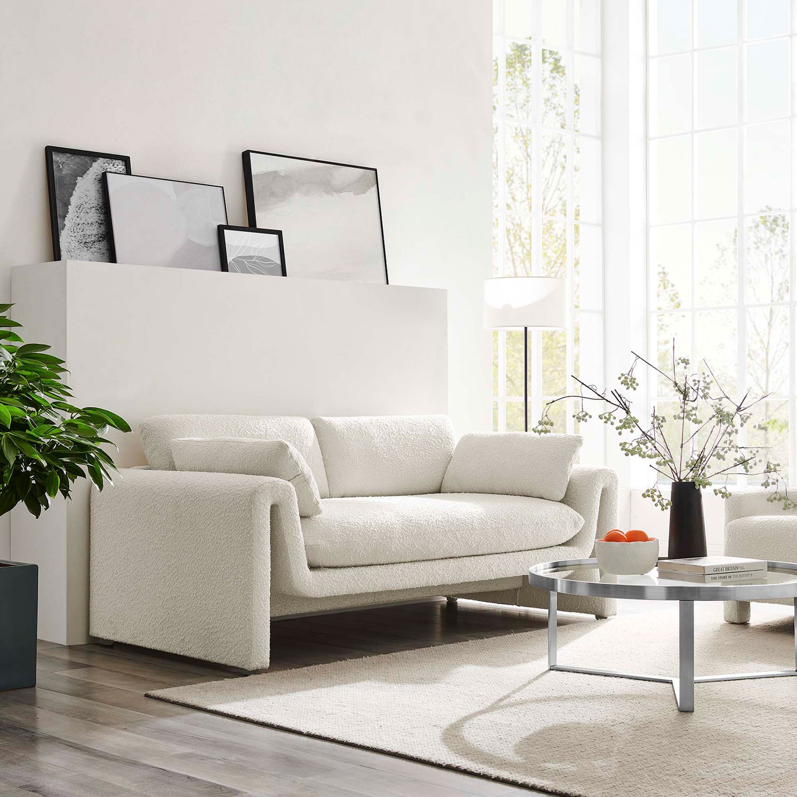 Ivory Waverly boucle sofa anchored in a modern living room with large windows and minimalist decor || EEI-6381-IVO || front_angle_room