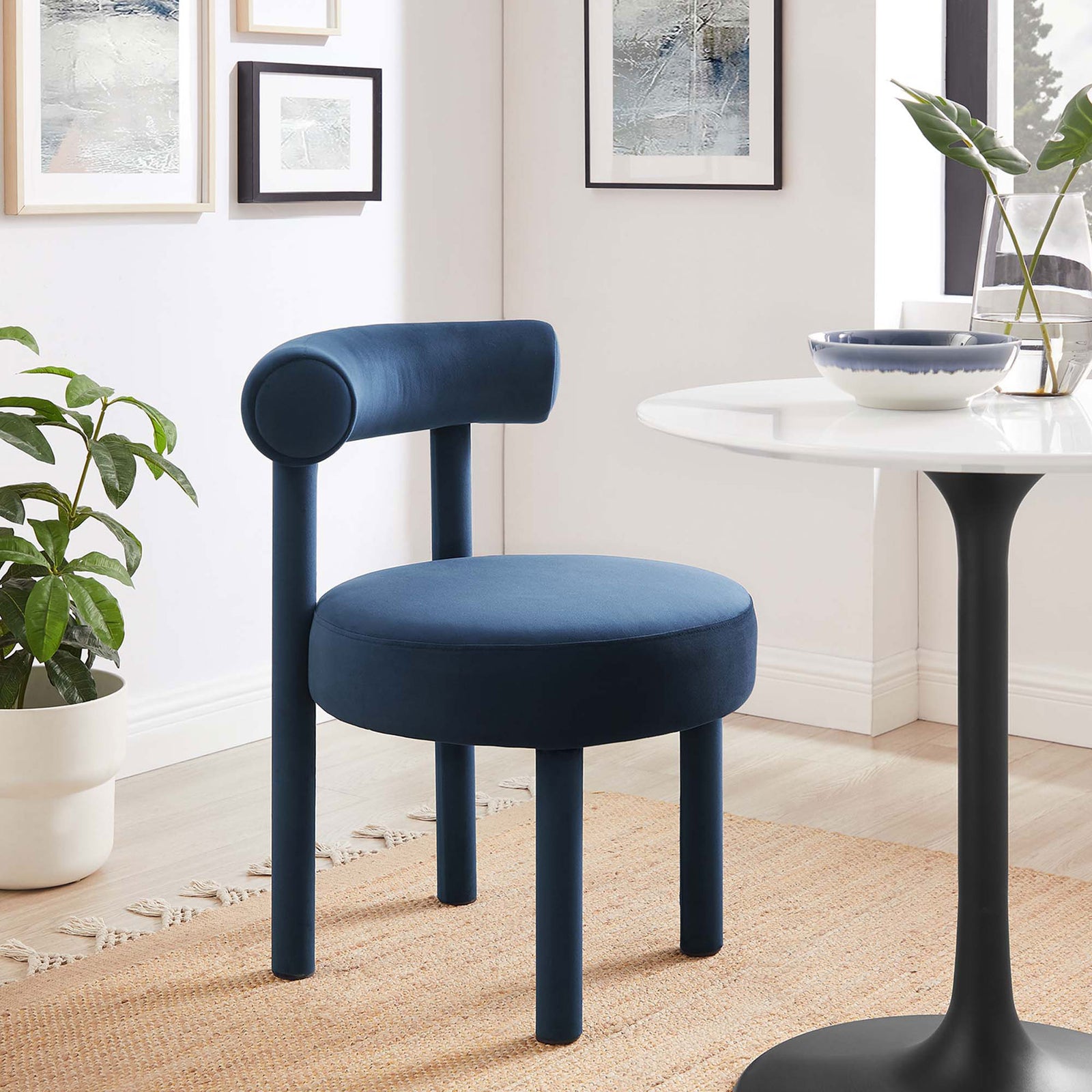 Midnight blue Toulouse dining chair brings plush velvet texture and sculptural lines to a modern sunlit dining room || EEI-6388-MID || front_angle_room