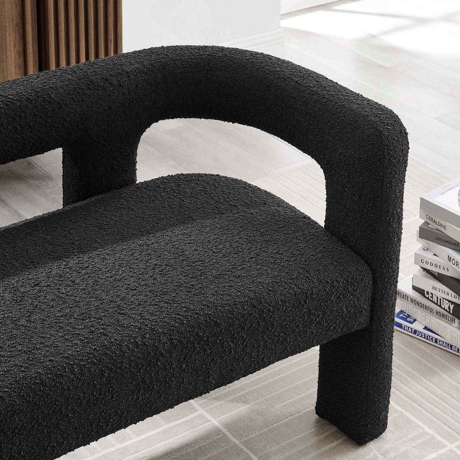 Black boucle loveseat styled in modern living room with light rug and stacked books || EEI-6477-BLK || detail_room