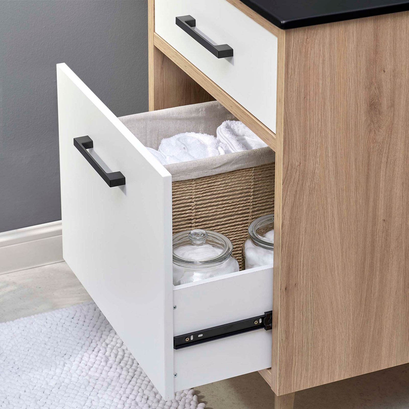 Spacious bottom drawer organizes towels and jars for a tidy bathroom || EEI-6499-BLK-OAK || storage_open_room
