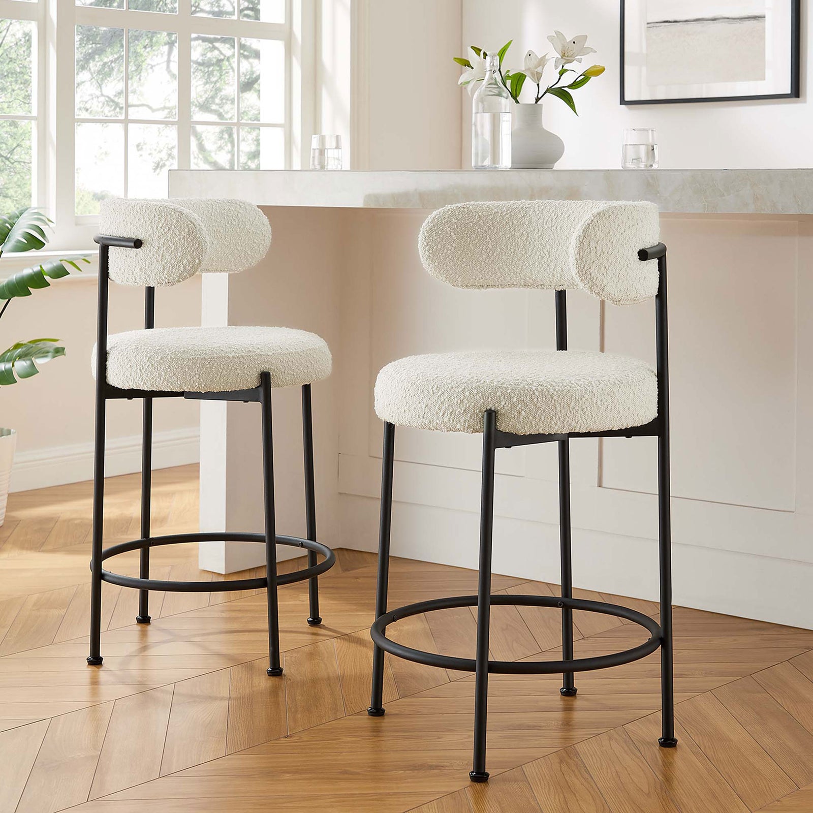 Pair of counter stools elevates casual dining with boucle seats and slim frames. || EEI-6518-IVO-BLK || front_angle_multi_room