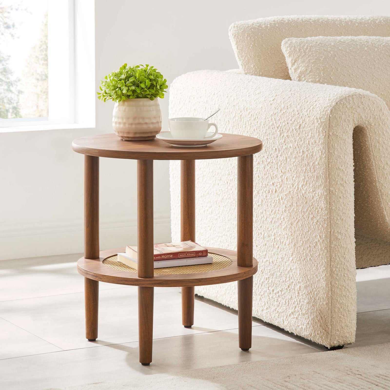 Torus walnut round side table beside a cozy sofa, topped with a plant and mug for inviting living room style || EEI-6527-WAL || front_angle_room