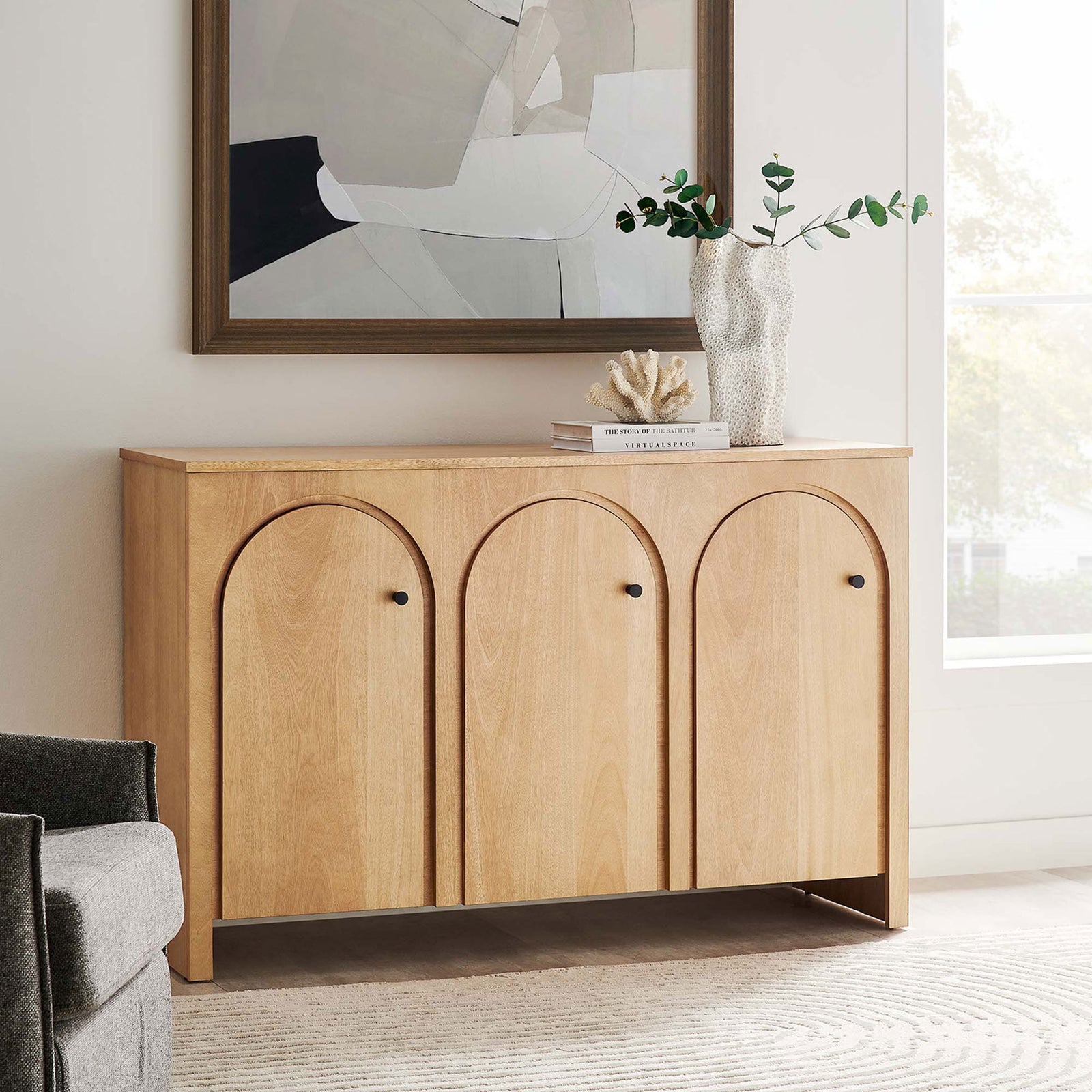 Oak arched door sideboard styled in a modern living room with art, greenery, and decorative accents || EEI-6536-OAK || front_angle_room