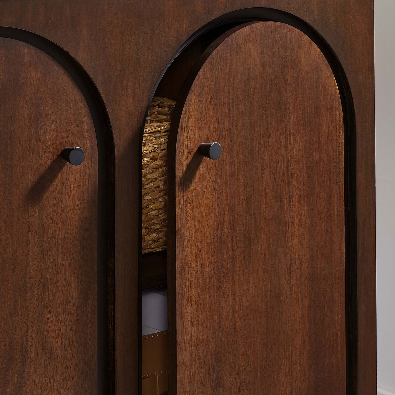 Partially open walnut doors reveal generous cabinet storage for baskets and boxes || EEI-6537-WAL || storage_open_room