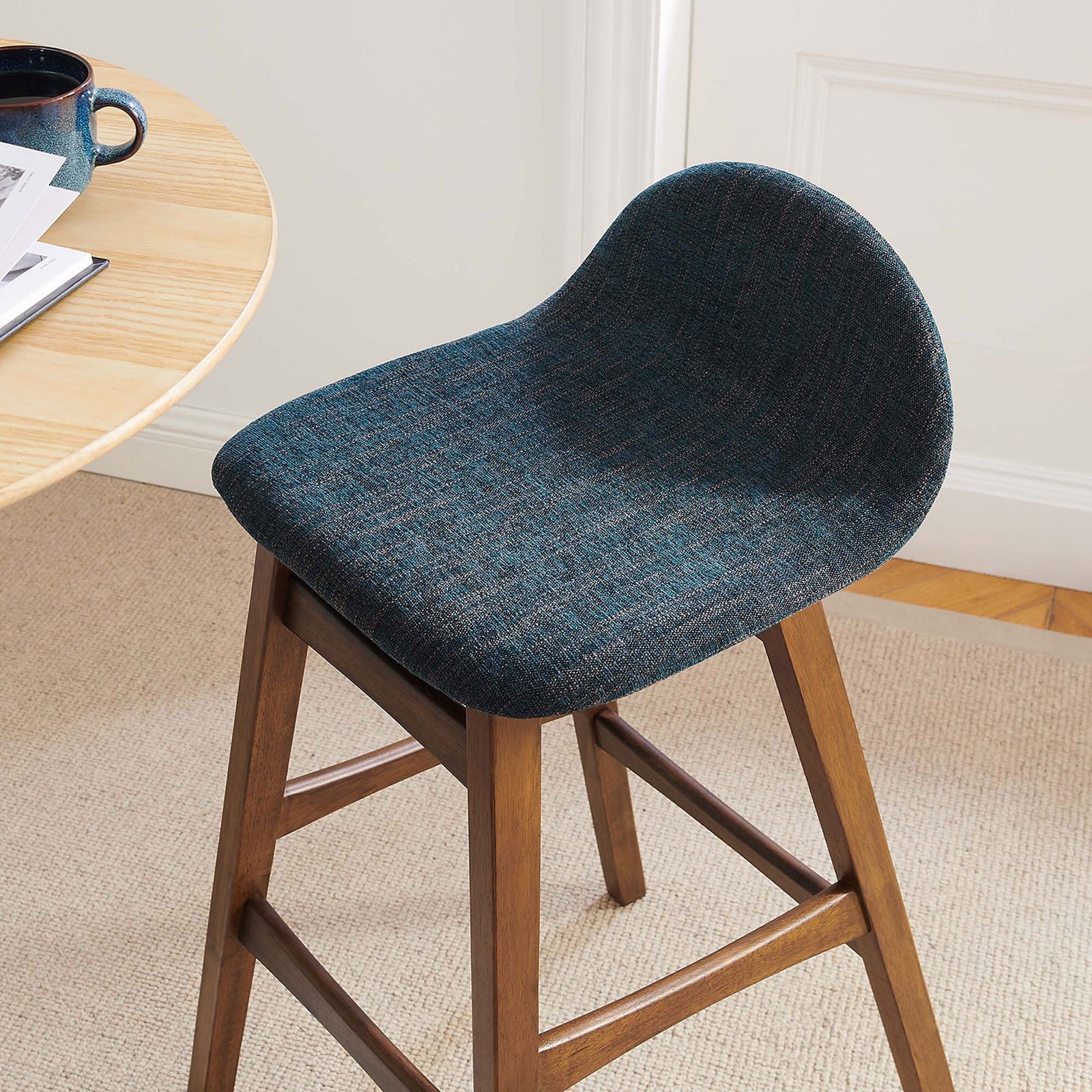 Crisp lines and cozy upholstery bring modern warmth to everyday dining. || EEI-6553-HEA || front_angle_room