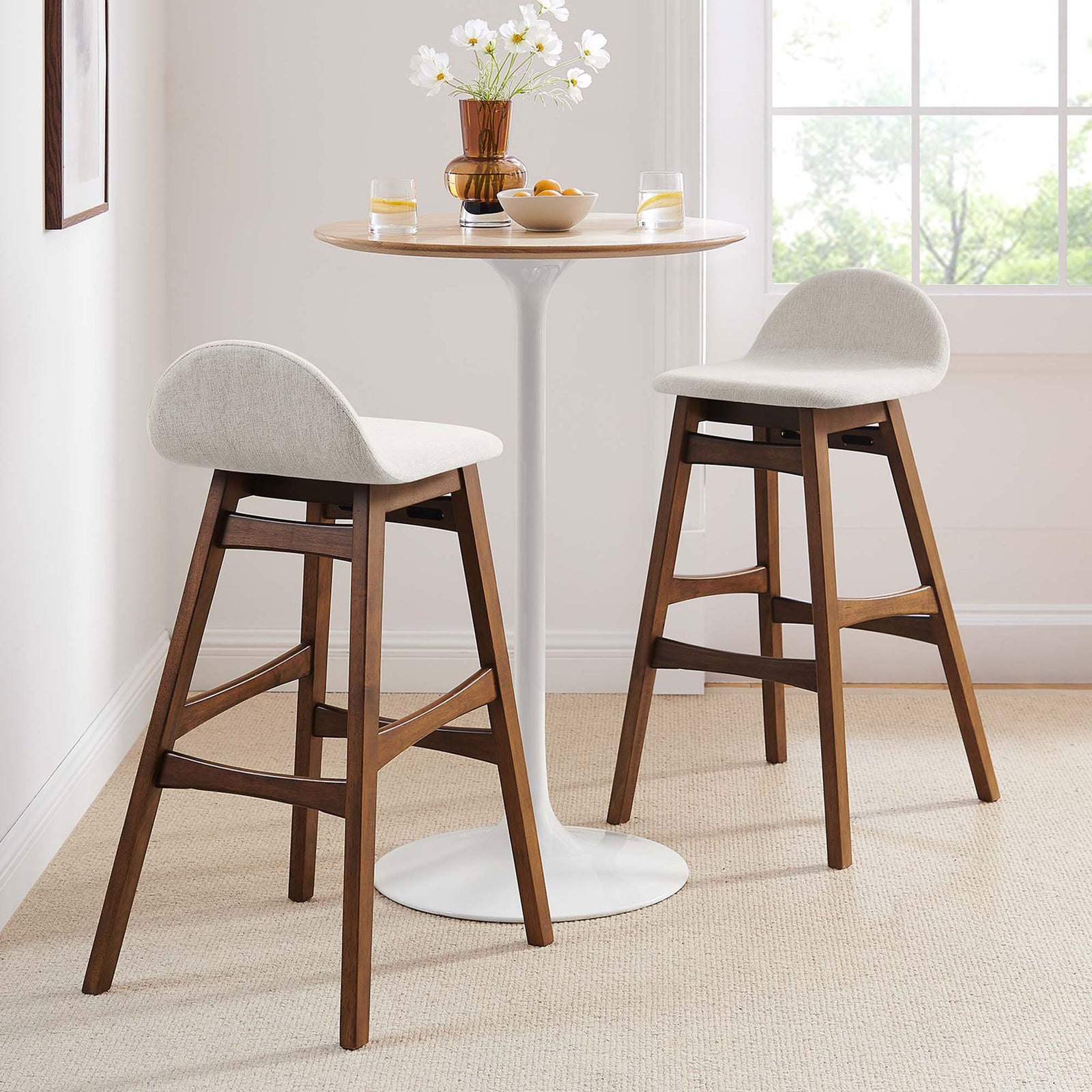 Pair of bar stools bringing warm wood and ivory comfort to a bright dining nook || EEI-6553-HEI || front_angle_multi_room