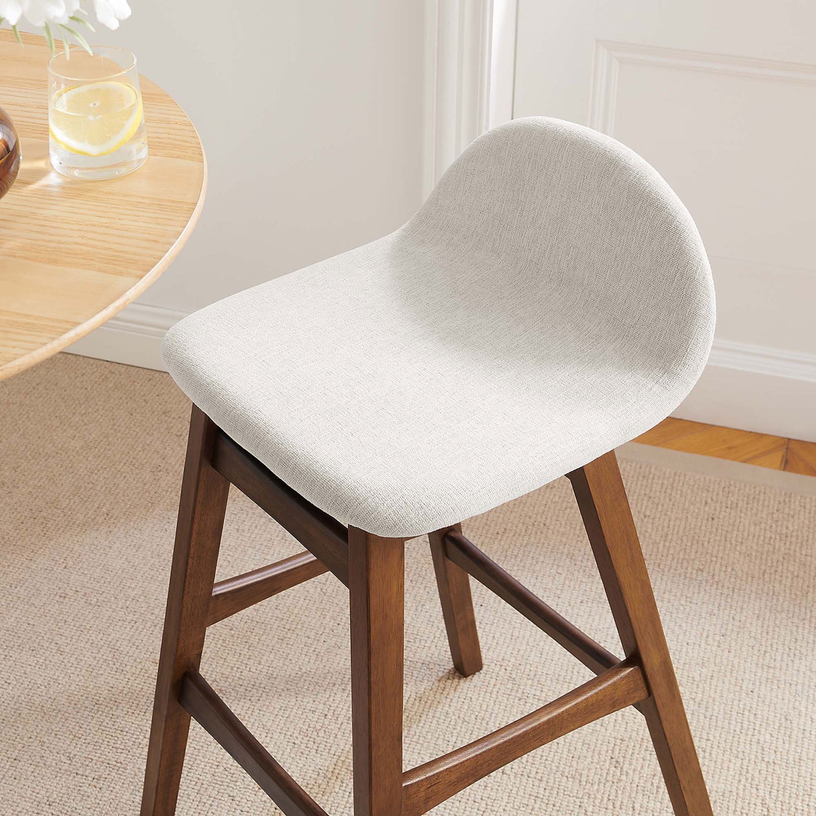 Ivory seat and curved back add soft contrast beside a round table in a cozy room || EEI-6553-HEI || detail_room