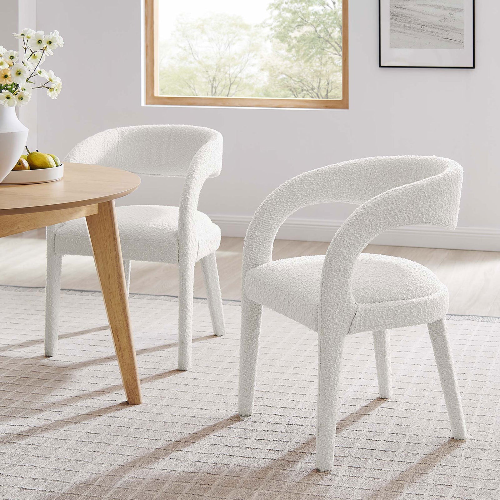 Pair of ivory boucle dining chairs around a light wood table for a soft, modern dining room look. || EEI-6562-IVO || front_angle_multi_room