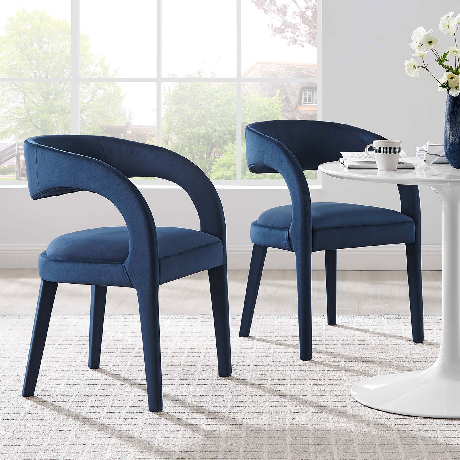 Set of two midnight blue velvet dining chairs bringing soft texture and sculptural lines to the dining room || EEI-6563-MID || front_angle_multi_room