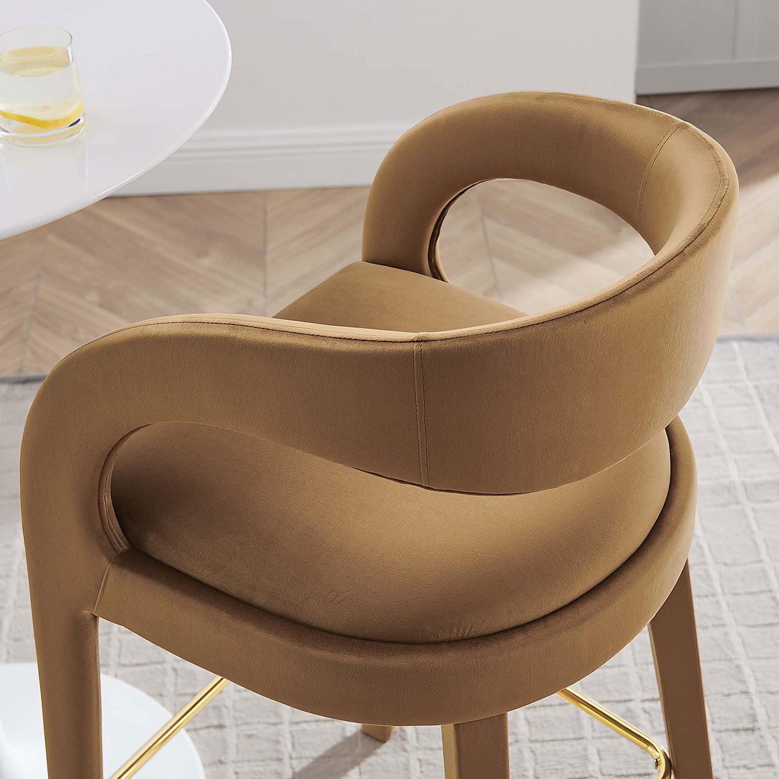 Rich brown velvet and a sculpted back add comfort and style with a gold footrest accent || EEI-6569-BRN-GLD || detail_room