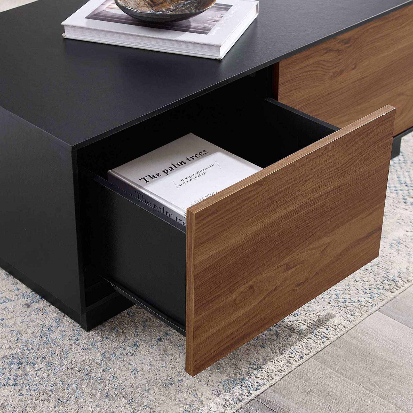 Open drawer reveals roomy storage for books and remotes in a cozy living room || EEI-6599-BLK-WAL || storage_open_room