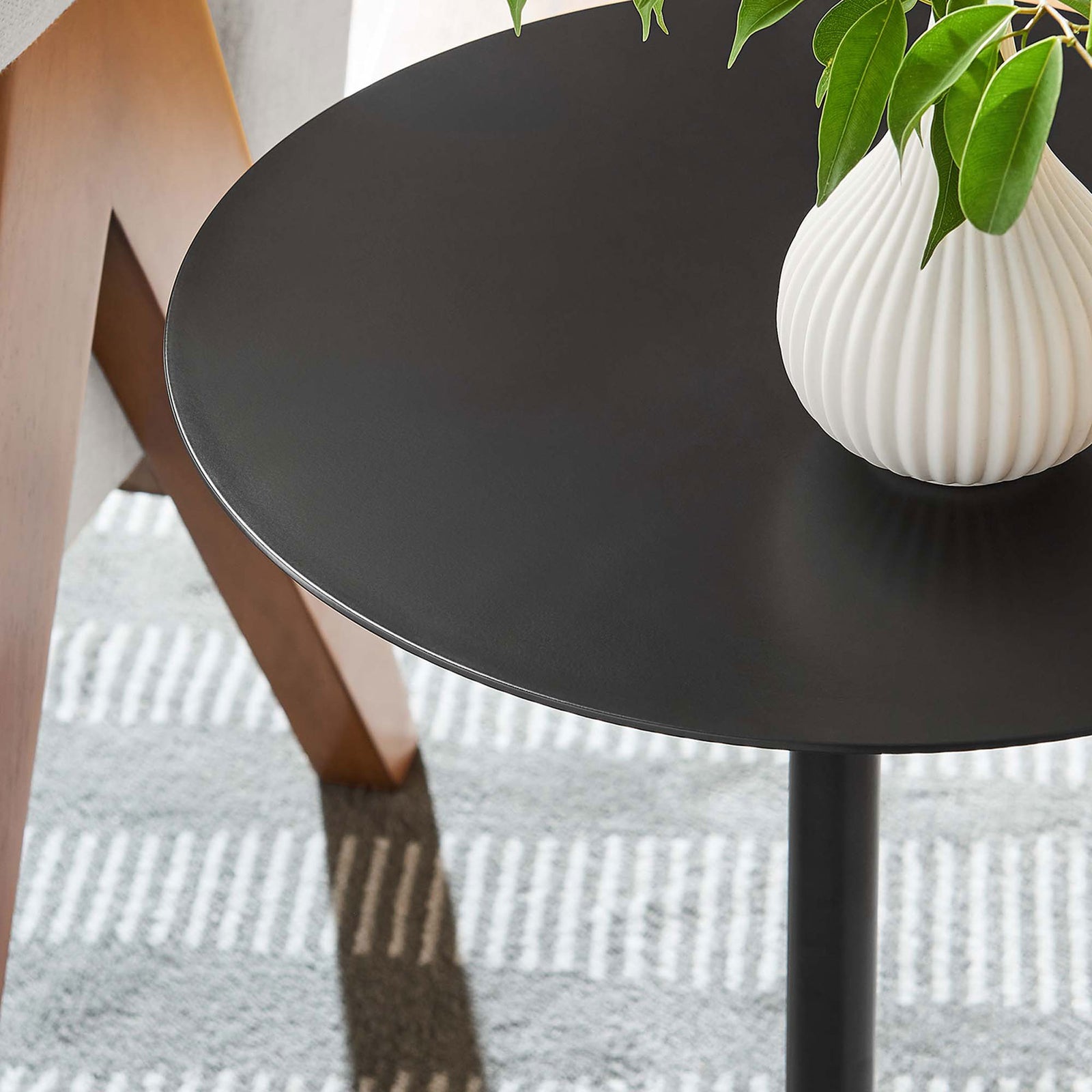 Styled tabletop vignette shows the black top beside a sofa, perfect for drinks or decor || EEI-6606-WHI-BLK || detail_room